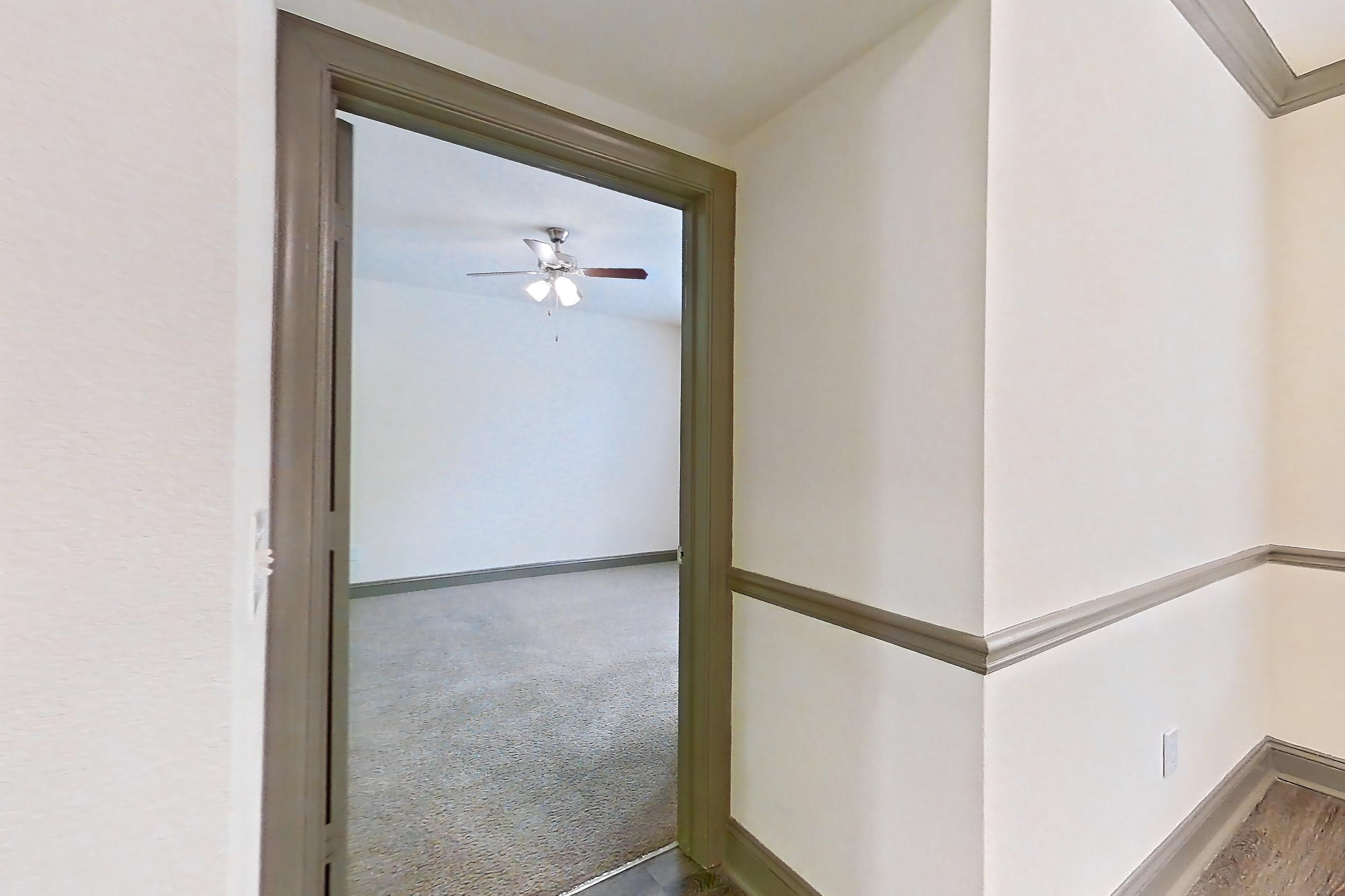 Kitchen with dark wood-finish flooring, dishwasher, electric range, light stone countertops, microwave, oven/range, and stainless steel appliances, Apartment 3407 at Marq Perimeter