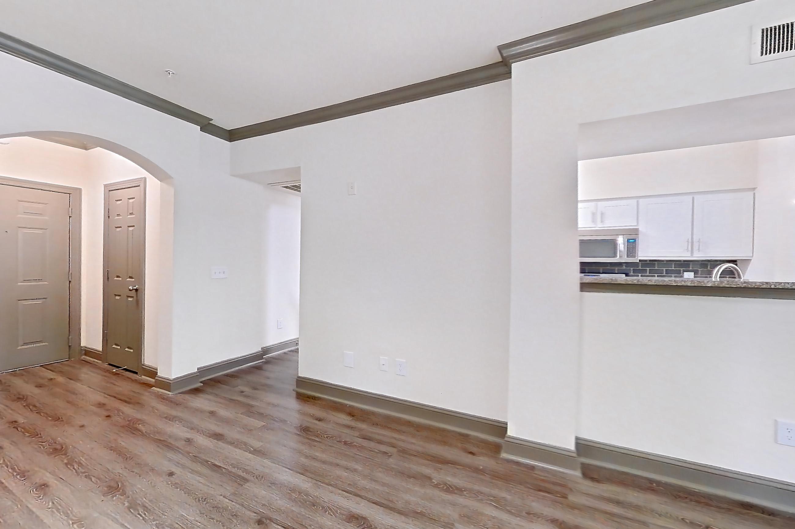 Living room with microwave and stainless steel appliances, Apartment 3407 at Marq Perimeter
