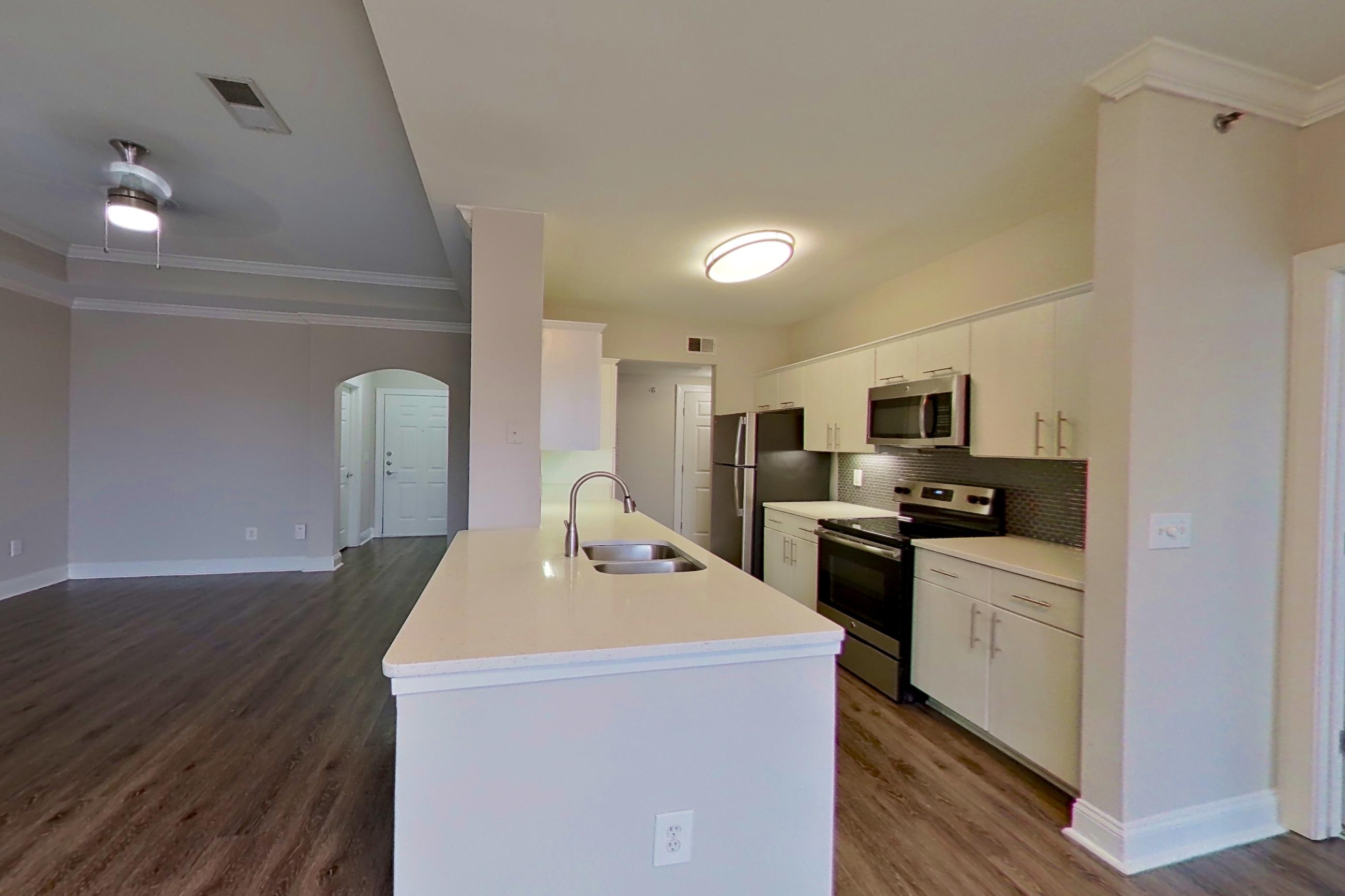Dining area with electric range, light countertops, microwave, oven/range, refrigerator, and stainless steel appliances, Apartment 3508 at Marq Perimeter