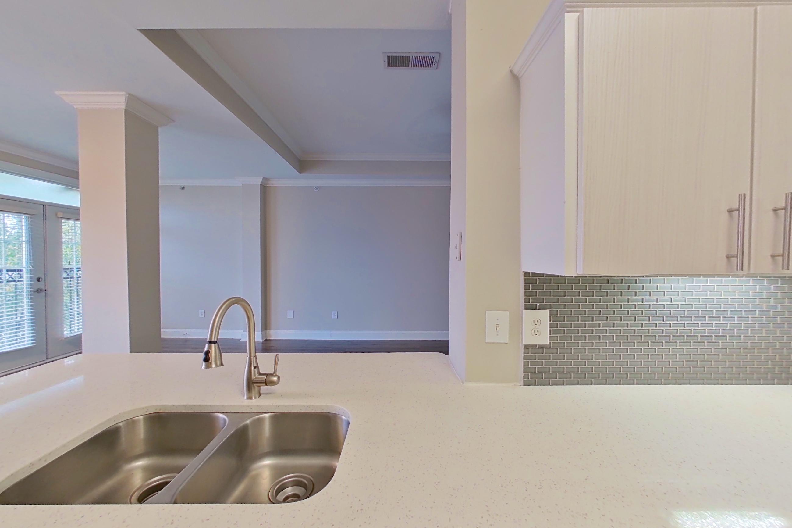 Kitchen with dishwasher, electric range, light countertops, light stone countertops, microwave, oven/range, refrigerator, and stainless steel appliances, Apartment 3508 at Marq Perimeter