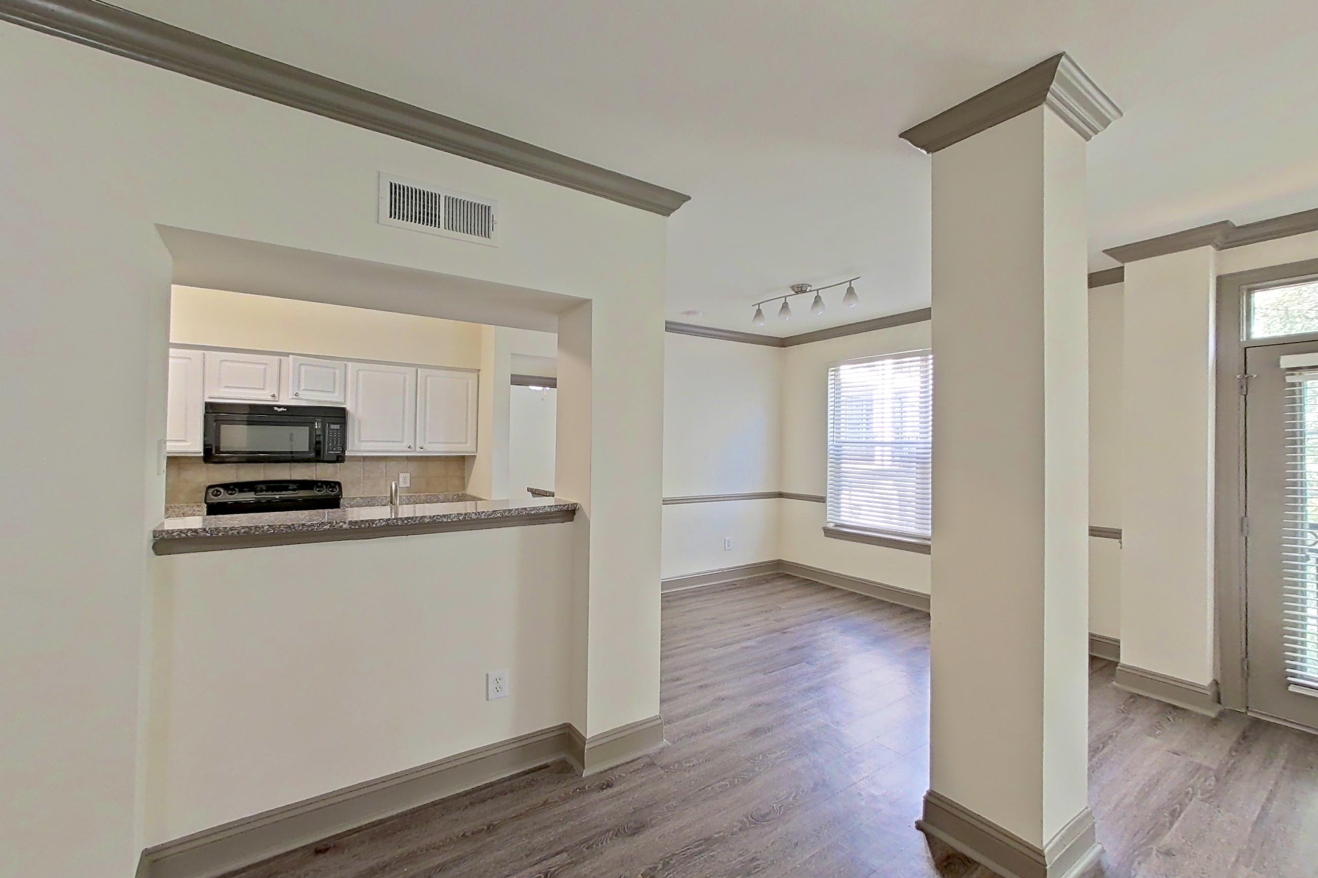 Living room with black appliances, electric range, and oven/range, Apartment 4303 at Marq Perimeter