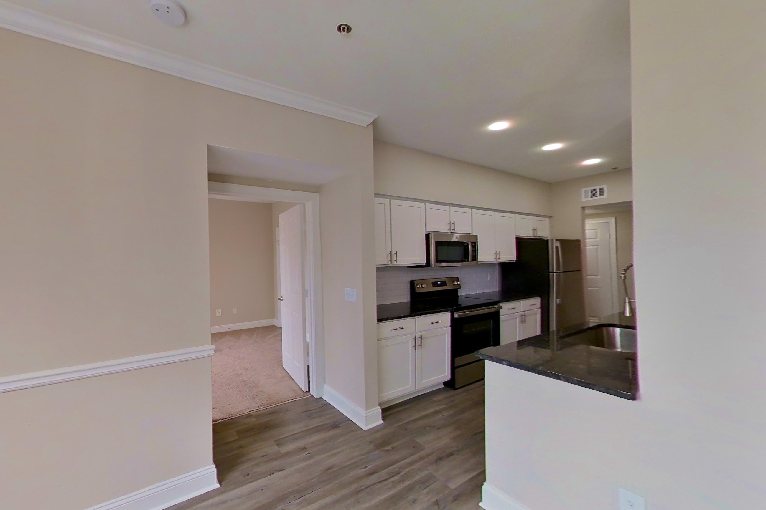 Dining area with dark countertops, electric range, oven/range, refrigerator, and stainless steel appliances, Apartment 4304 at Marq Perimeter