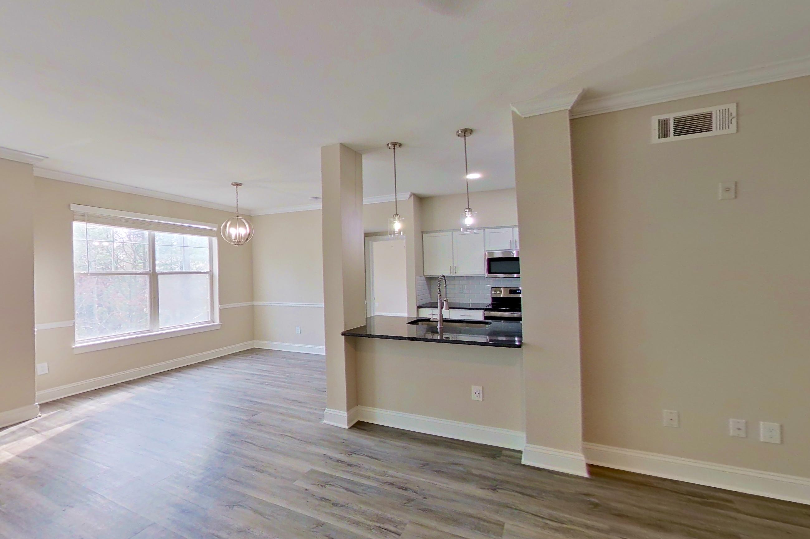 Living room with electric range, oven/range, and stainless steel appliances, Apartment 4304 at Marq Perimeter