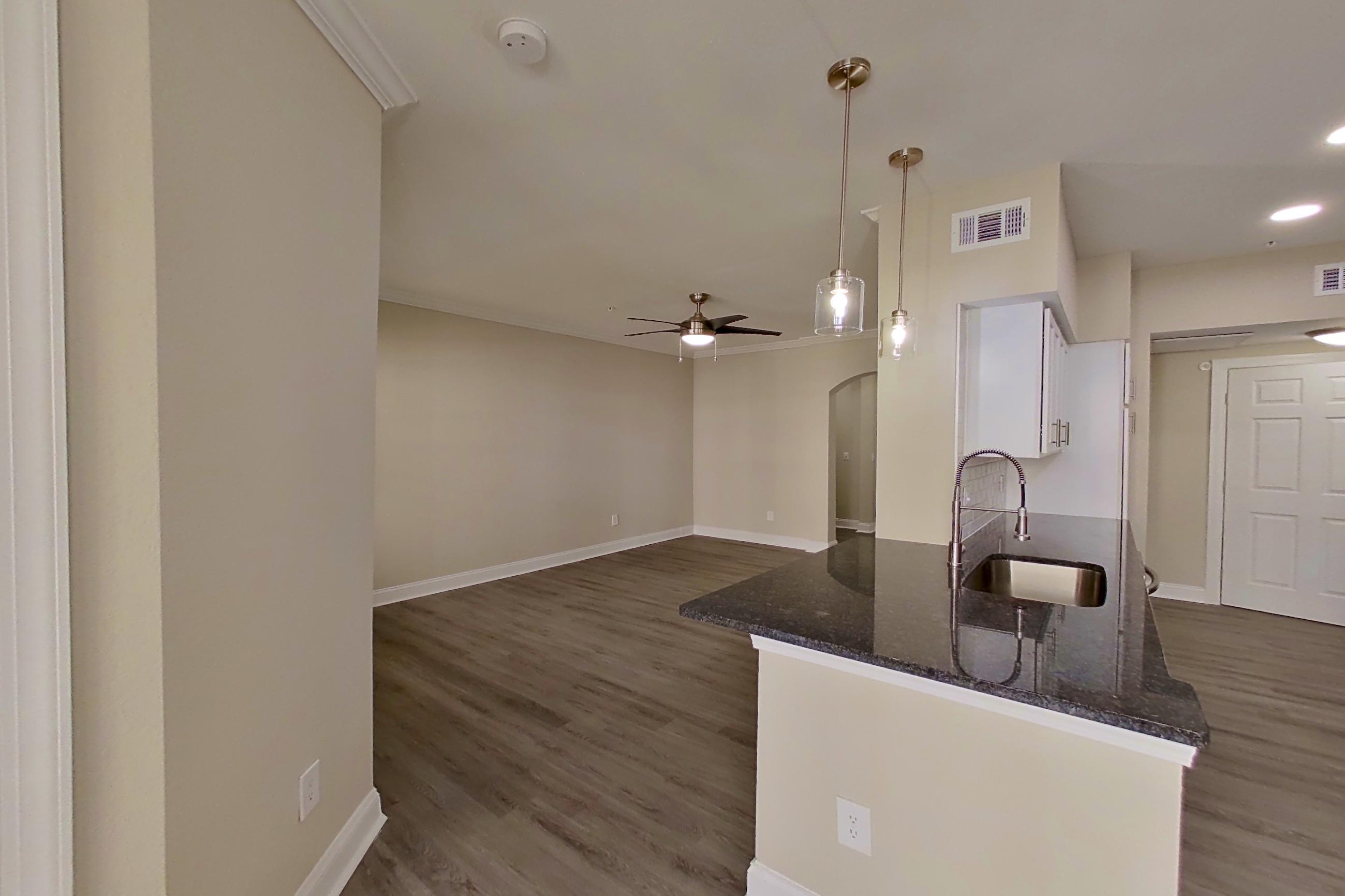 Dining area with dark countertops, electric range, light wood-finish flooring, microwave, oven/range, refrigerator, and stainless steel appliances, Apartment 5313 at Marq Perimeter