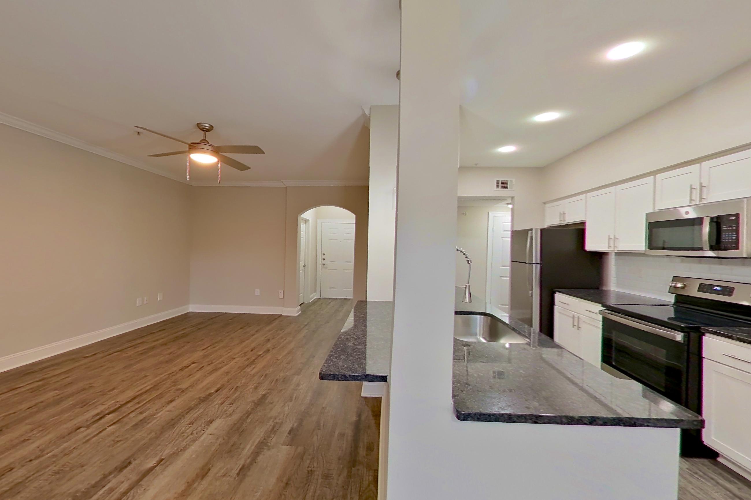 Dining area with dark stone countertops, electric range, microwave, oven/range, and stainless steel appliances, Apartment 6134 at Marq Perimeter