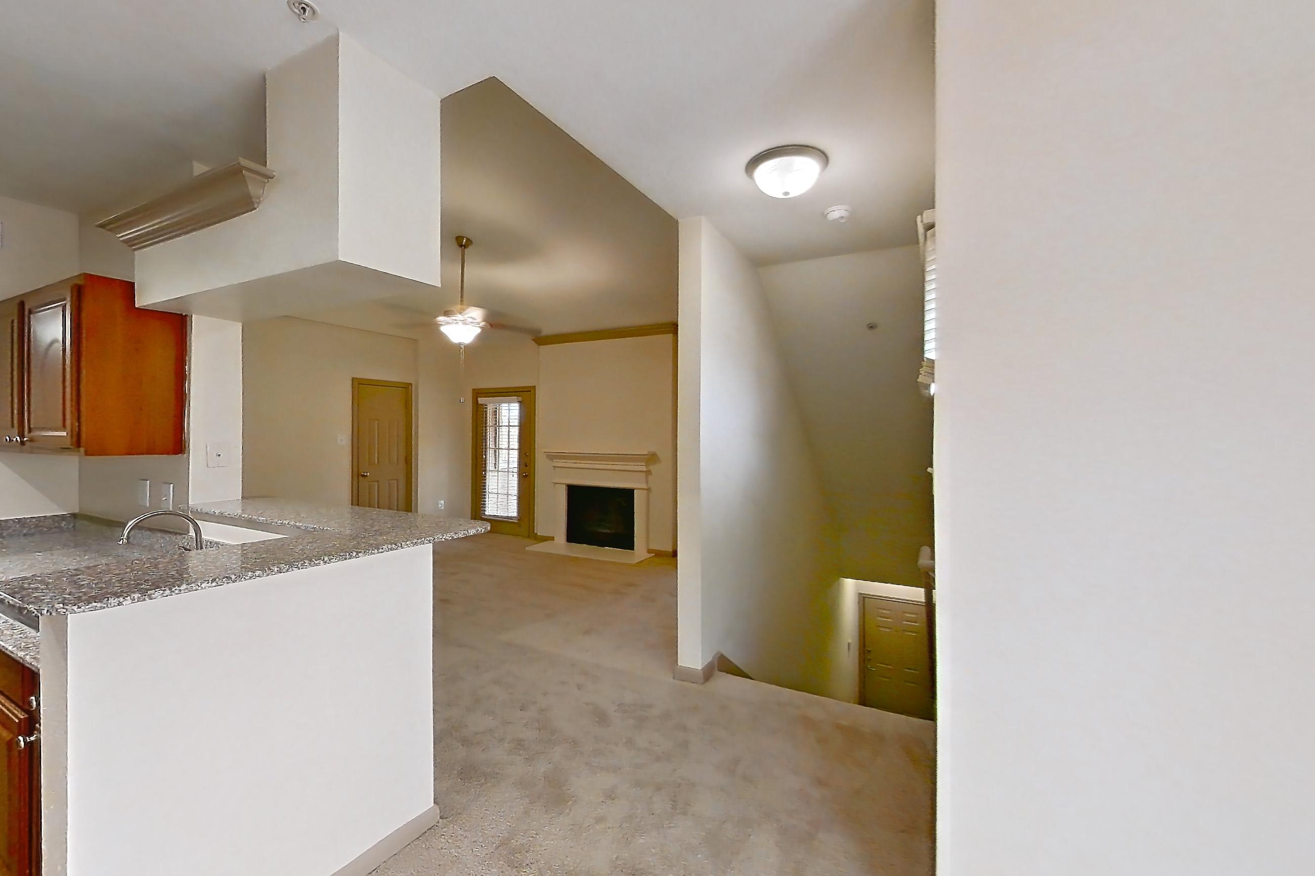 Dining room with black appliances, electric range, fireplace, light carpet, light stone countertops, light wood-finish flooring, oven/range, and refrigerator, Apartment 0425 at Marquis on Park Row