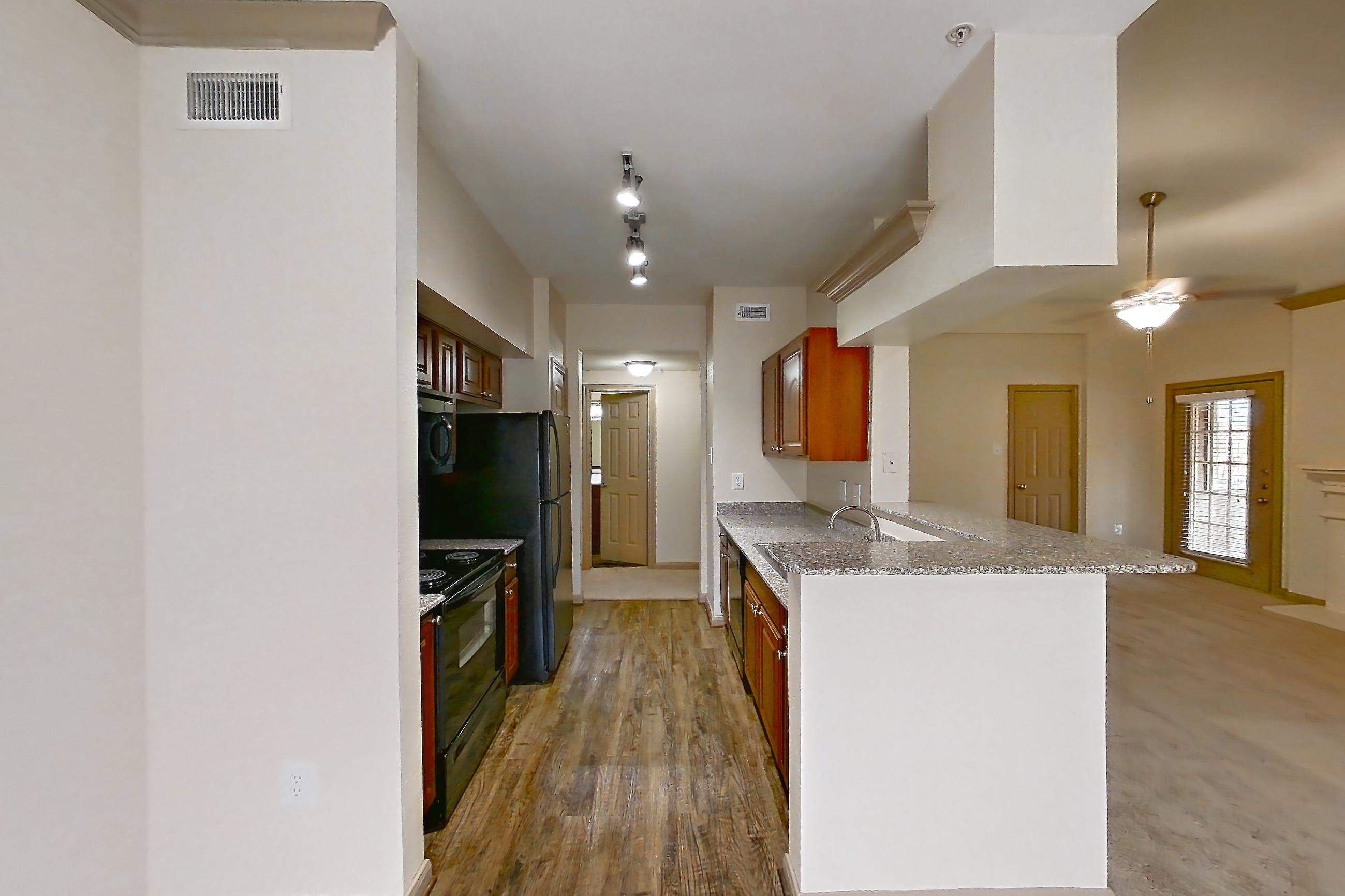 Dining room with black appliances, electric range, fireplace, light carpet, light stone countertops, light wood-finish flooring, oven/range, and refrigerator, Apartment 0425 at Marquis on Park Row