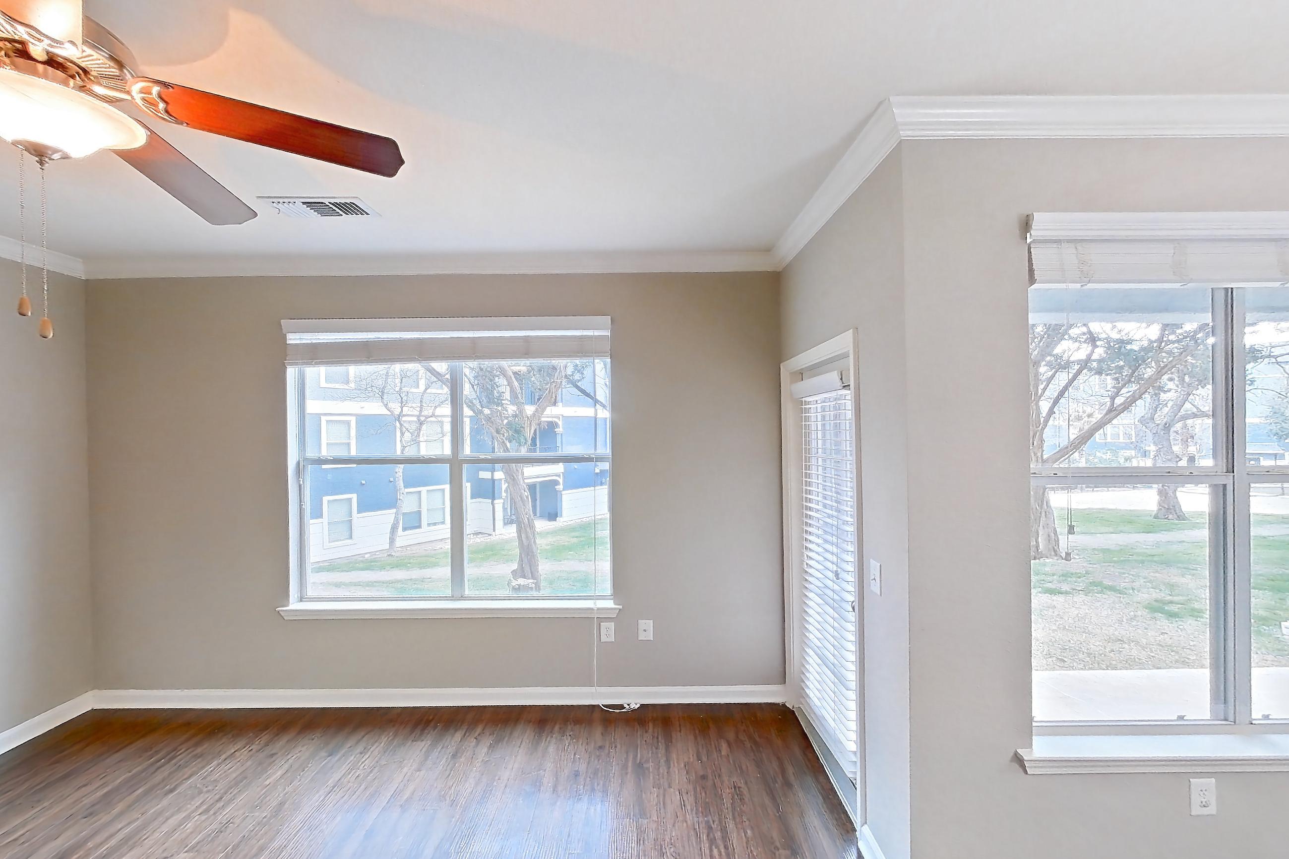 Living room with dark wood-finish flooring, Apartment 0515 at Marquis at Crown Ridge