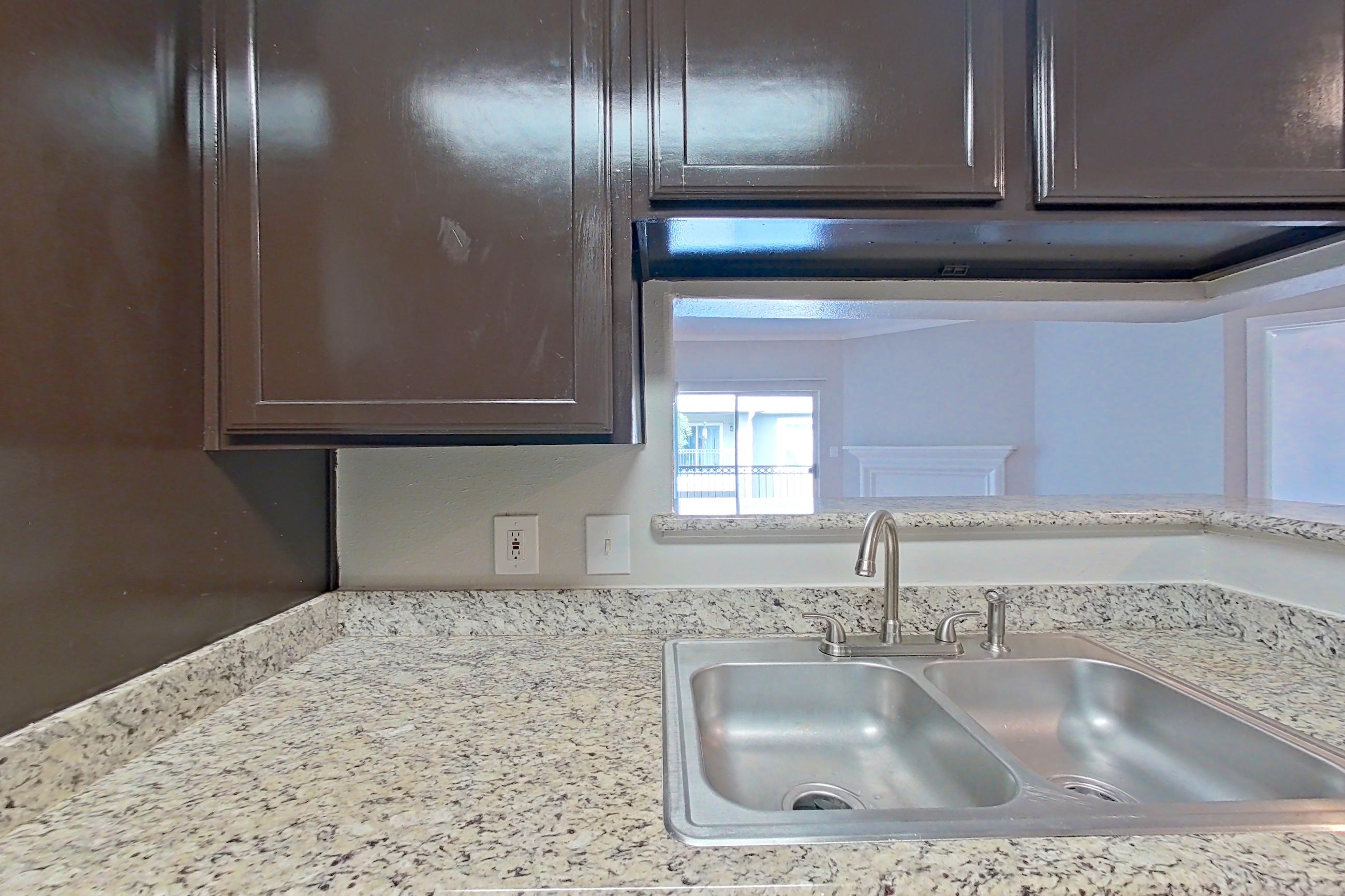 Kitchen with black appliances, electric range, light stone countertops, light wood-finish flooring, oven/range, and refrigerator, Apartment 0137 at Marquis on Westheimer