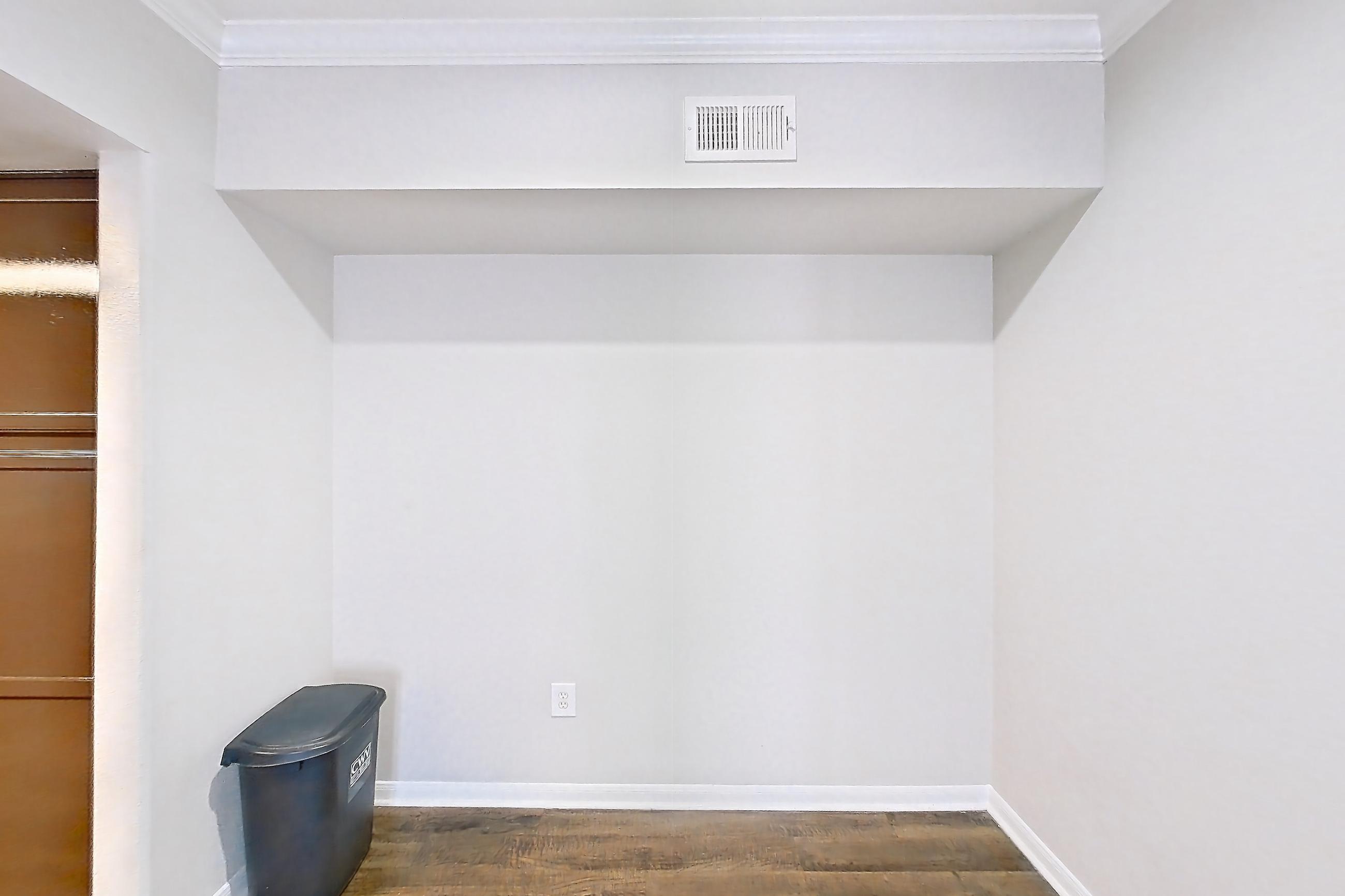Dining room with black appliances, electric range, fireplace, light countertops, light stone countertops, light wood-finish flooring, oven/range, and refrigerator, Apartment 0323 at Marquis on Westheimer