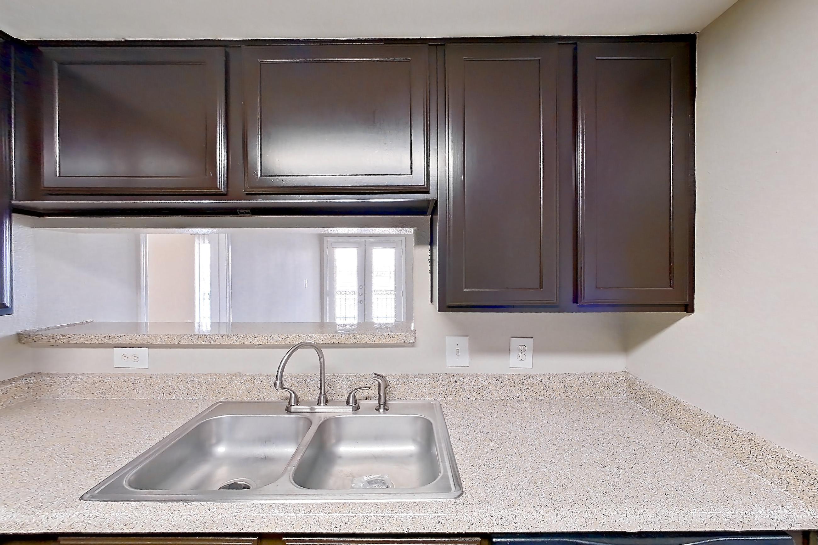 Kitchen with black appliances, dishwasher, electric range, light stone countertops, light wood-finish flooring, microwave, and oven/range, Apartment 0336 at Marquis on Westheimer