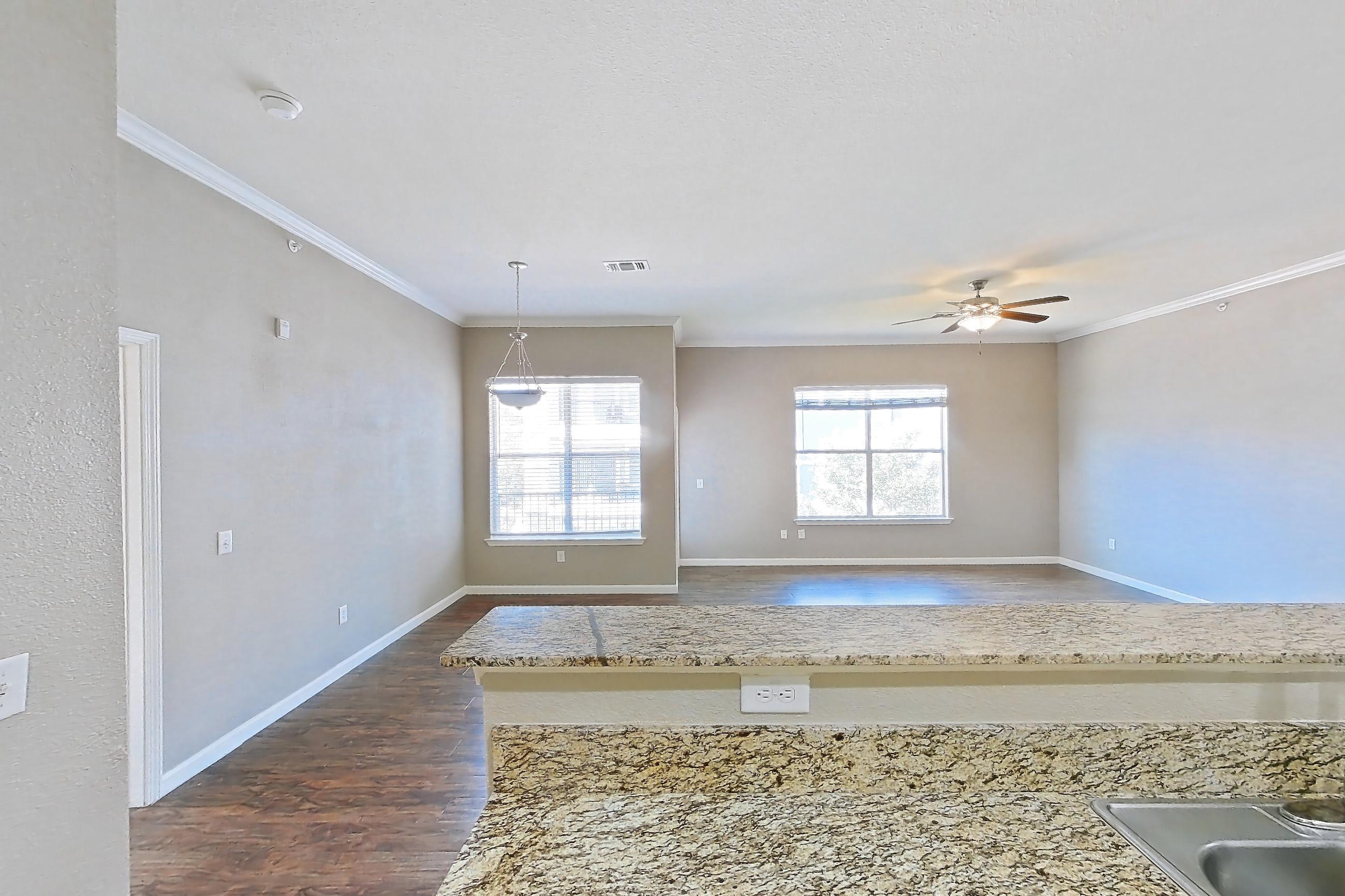 Kitchen with light stone countertops and light tile flooring, Apartment 0847 at Marquis at Crown Ridge