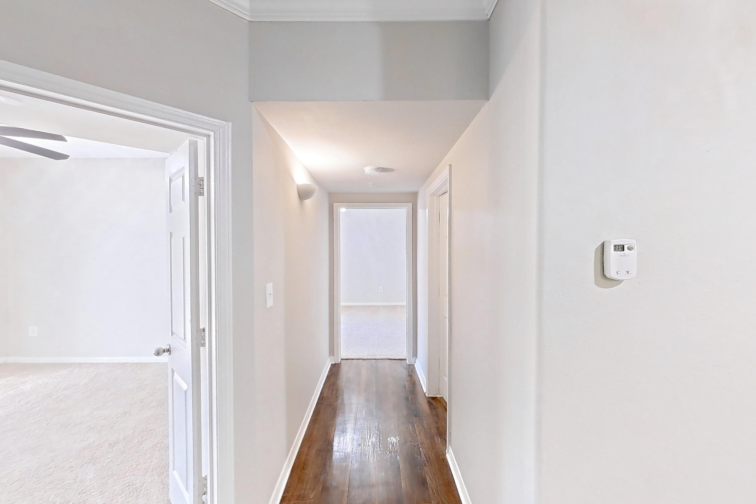 Living space with dark carpet, dark wood-finish flooring, electric range, fireplace, light stone countertops, oven/range, and stainless steel appliances, Apartment 0433 at Marquis on Westheimer