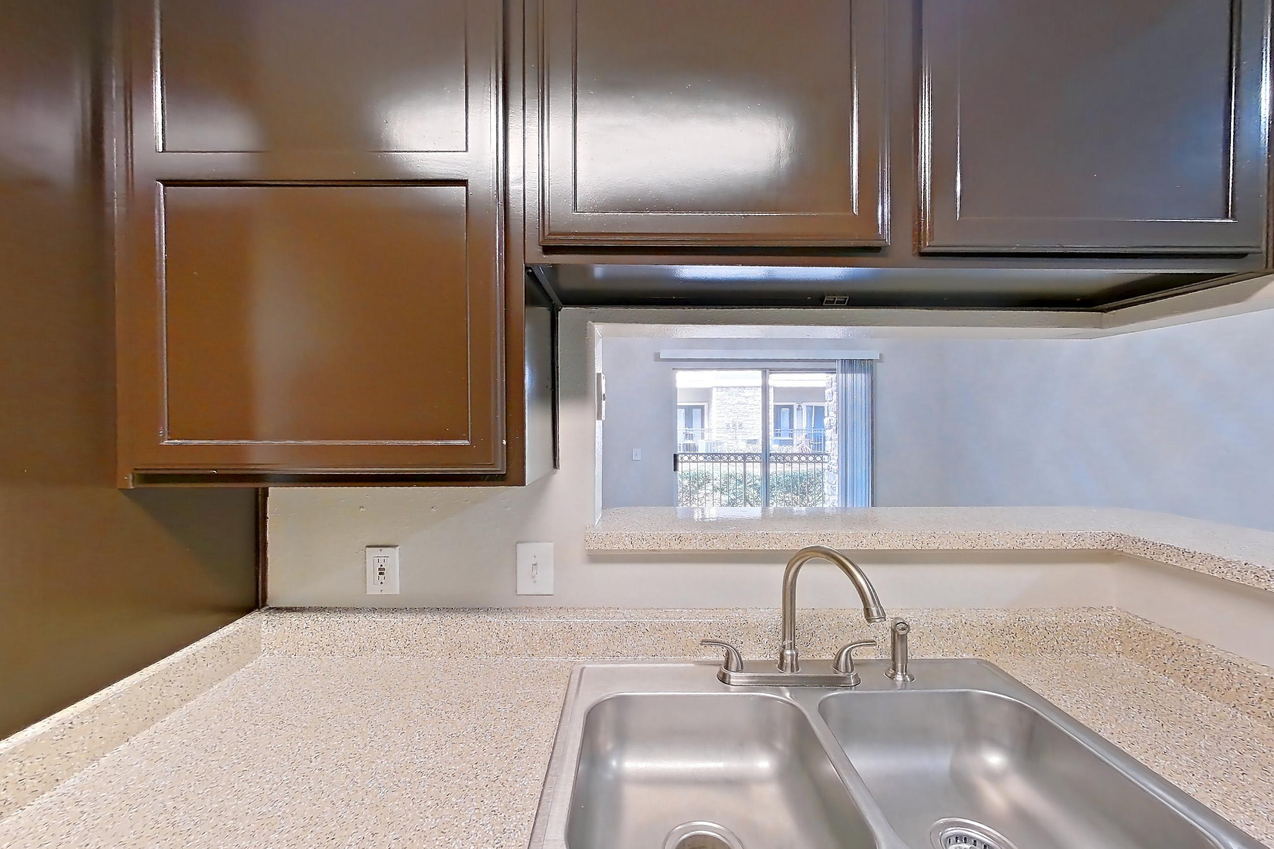 Kitchen with black appliances, dishwasher, electric range, light stone countertops, light wood-finish flooring, oven/range, refrigerator, and white appliances, Apartment 0615 at Marquis on Westheimer
