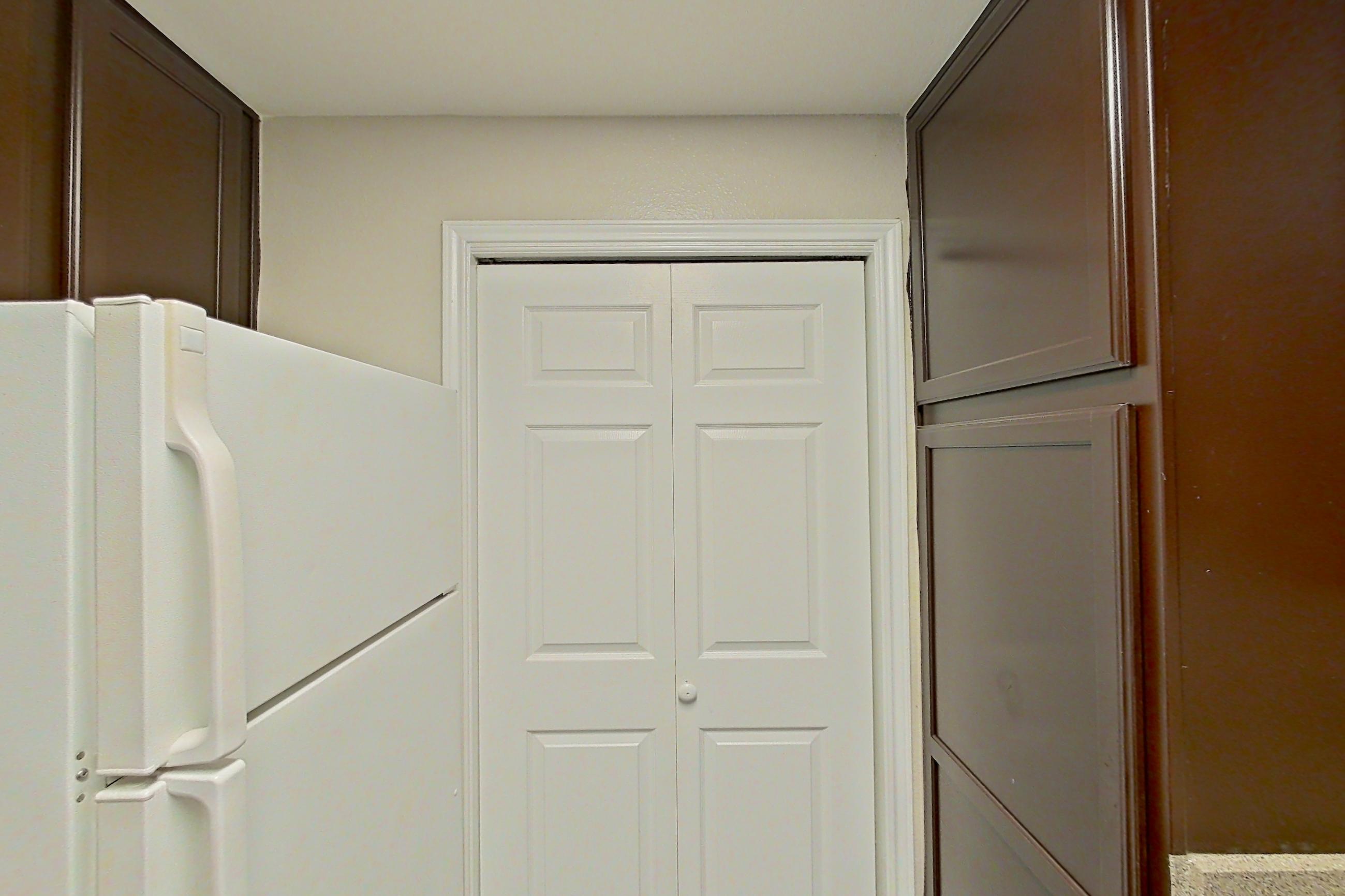 Kitchen with black appliances, dishwasher, electric range, light countertops, microwave, oven/range, refrigerator, and white appliances, Apartment 0631 at Marquis on Westheimer