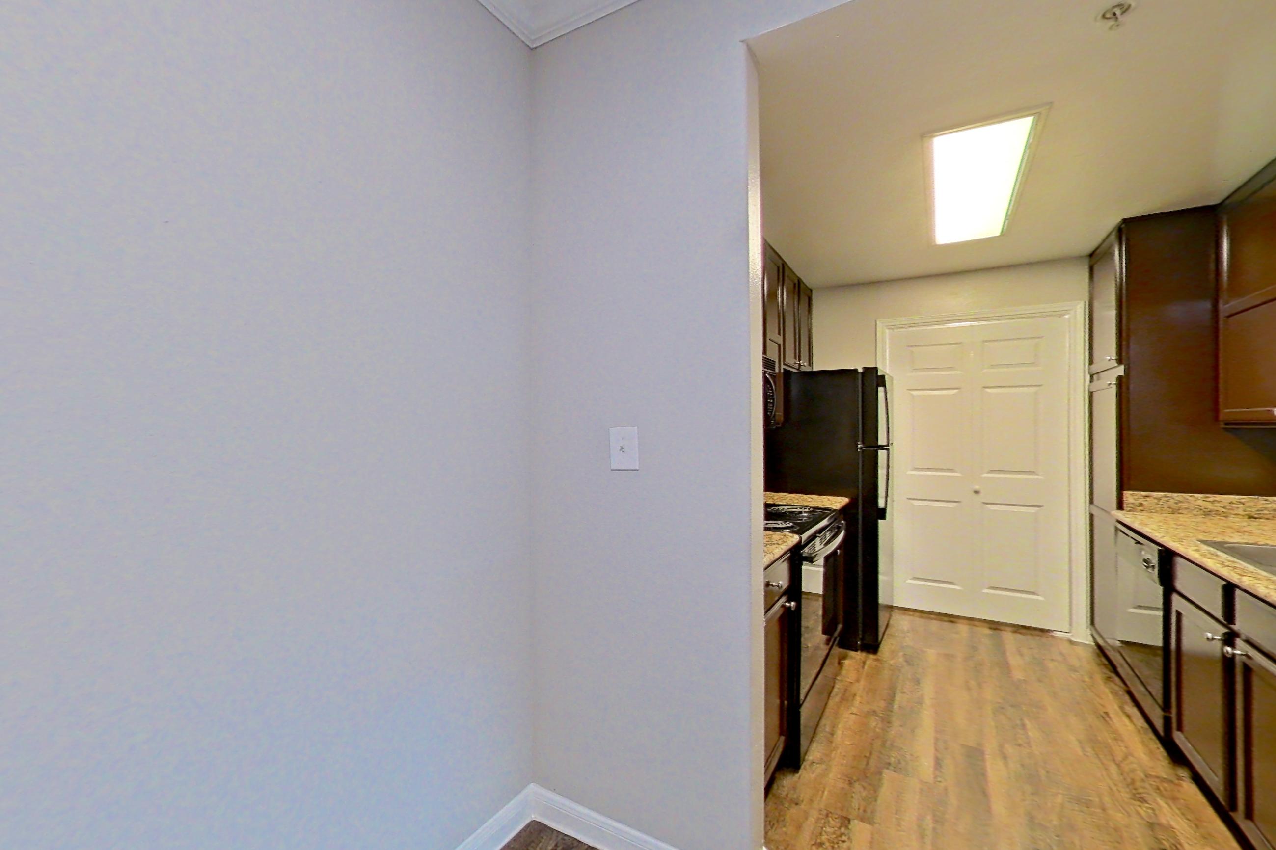 Dining room with dark wood-finish flooring and light stone countertops, Apartment 0635 at Marquis on Westheimer