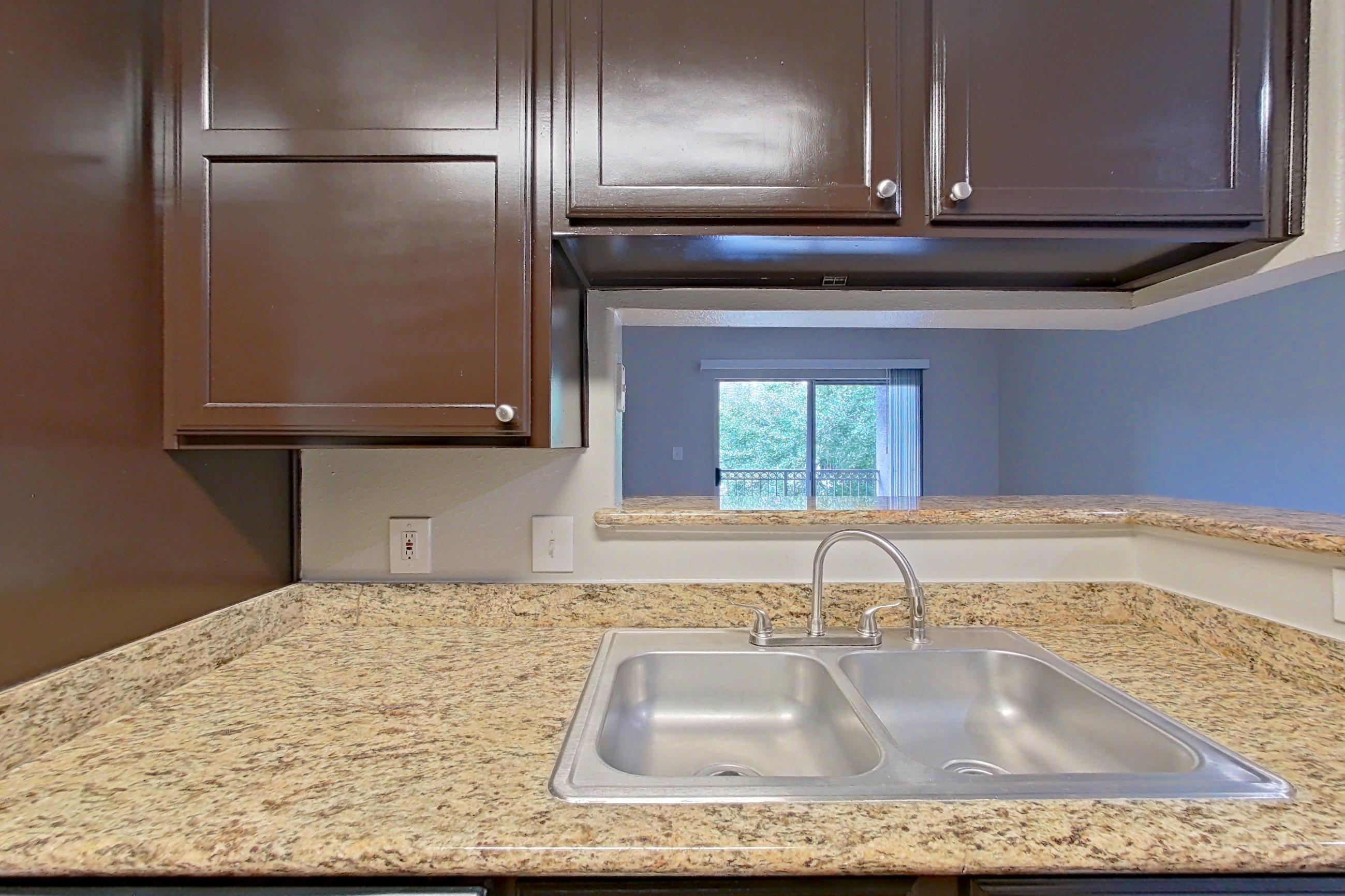 Kitchen with black appliances, dishwasher, light stone countertops, oven/range, and refrigerator, Apartment 0635 at Marquis on Westheimer