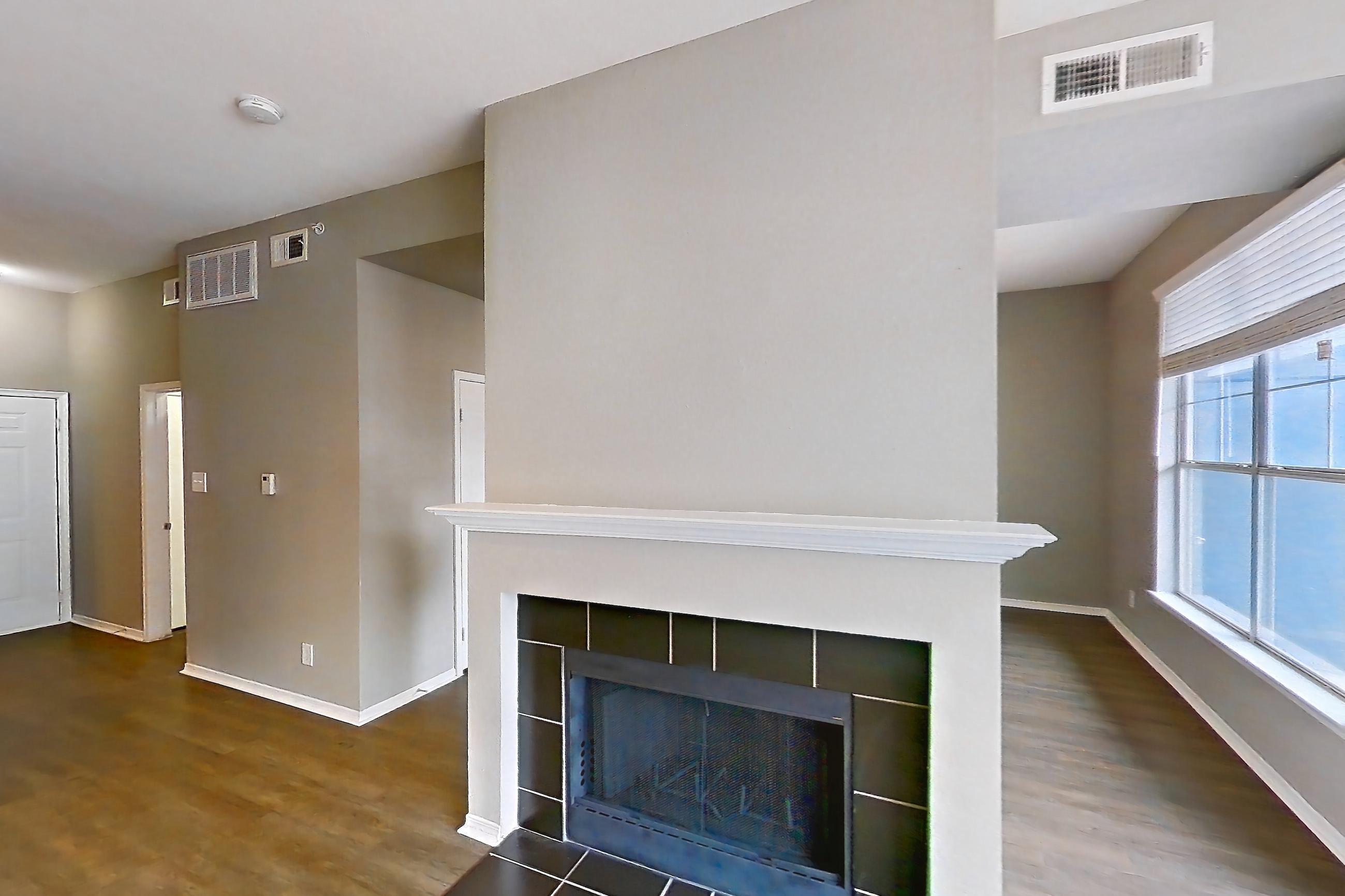 Living room with fireplace and tile fireplace, Apartment 01-01313 at Marquis on Gaston