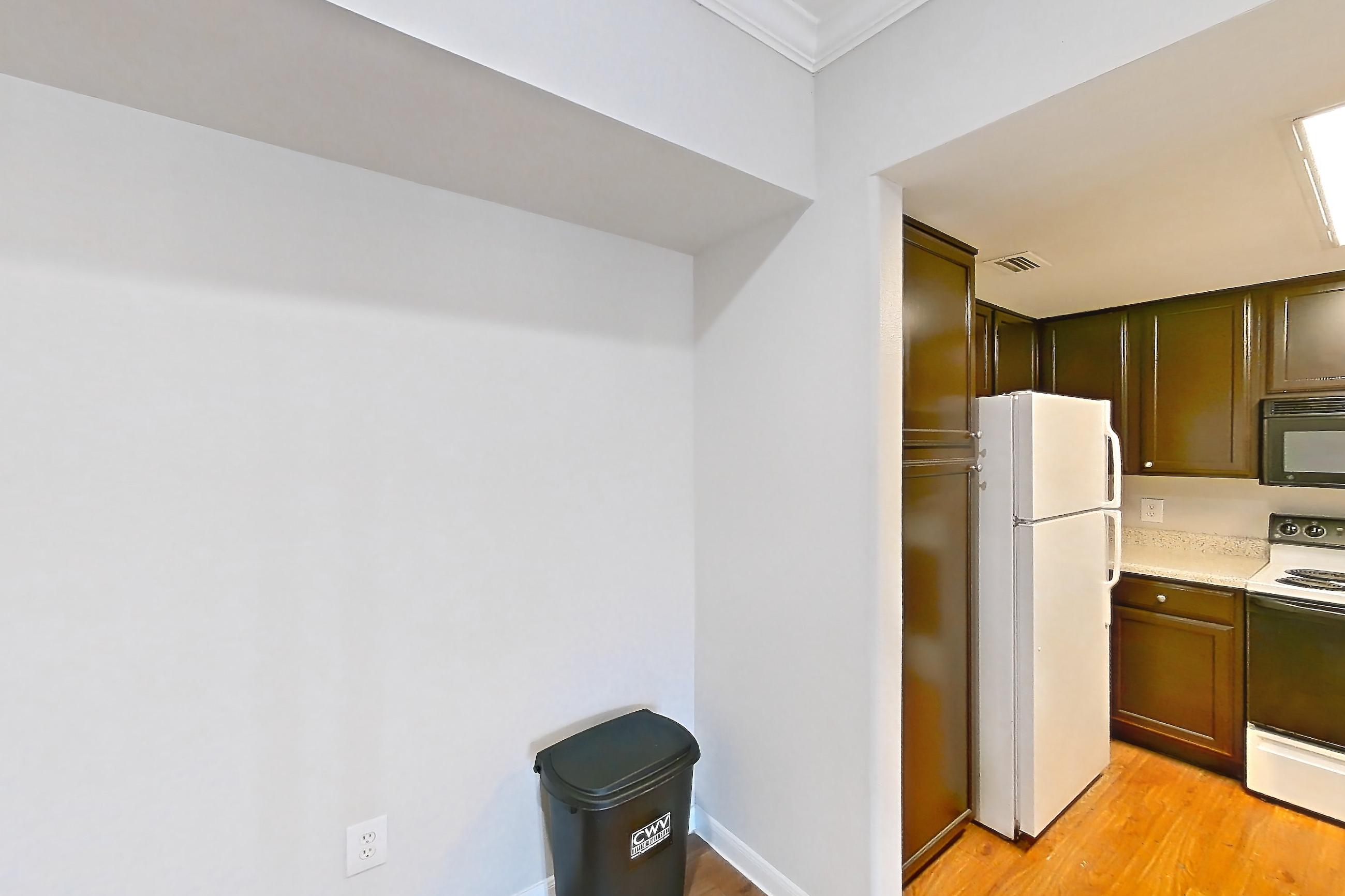 Dining room with dishwasher, electric range, fireplace, light countertops, light wood-finish flooring, oven/range, refrigerator, white appliances, and wood-finish flooring, Apartment 0732 at Marquis on Westheimer
