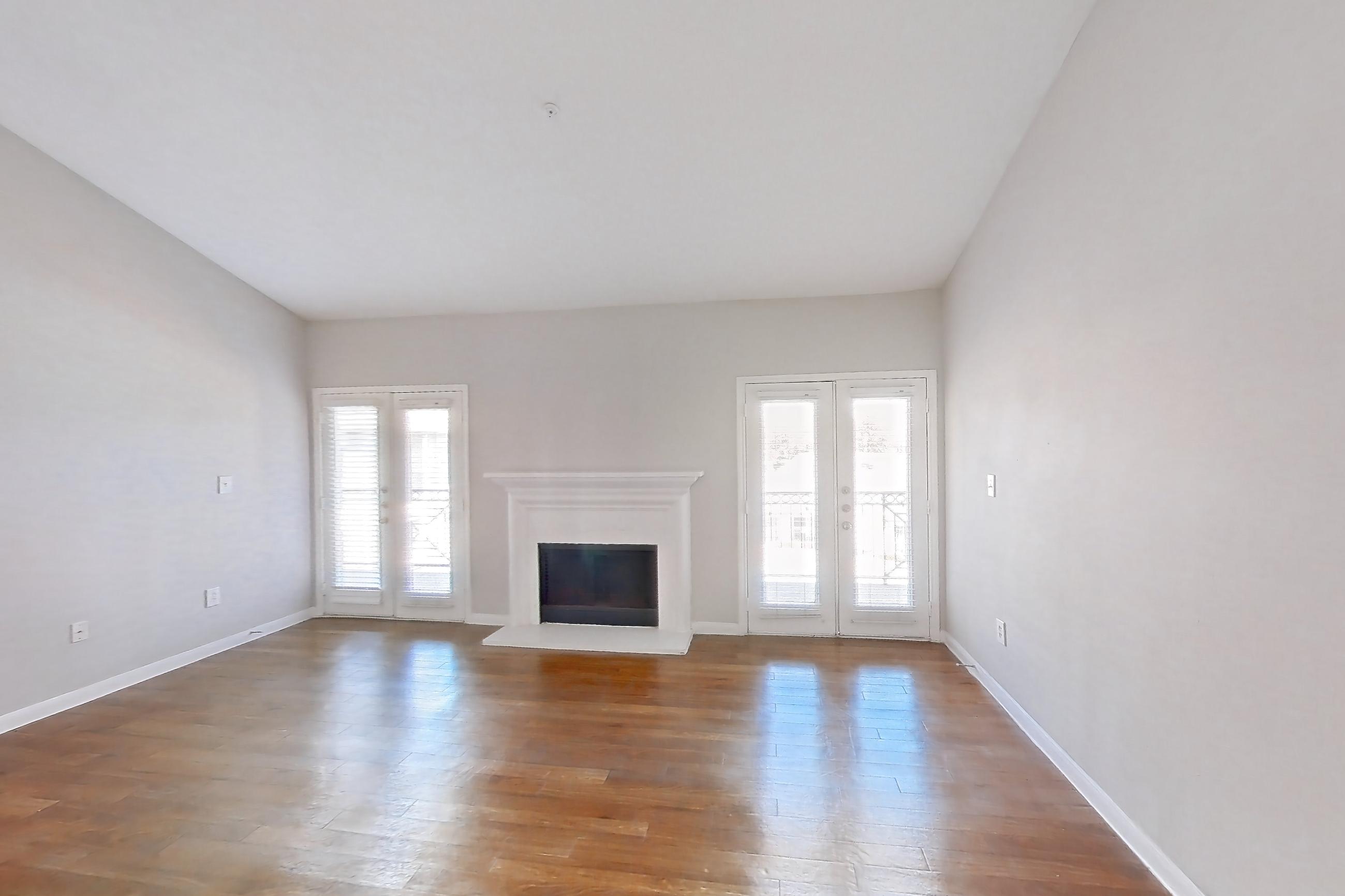 Living space with fireplace, light wood-finish flooring, and wood-finish flooring, Apartment 0732 at Marquis on Westheimer