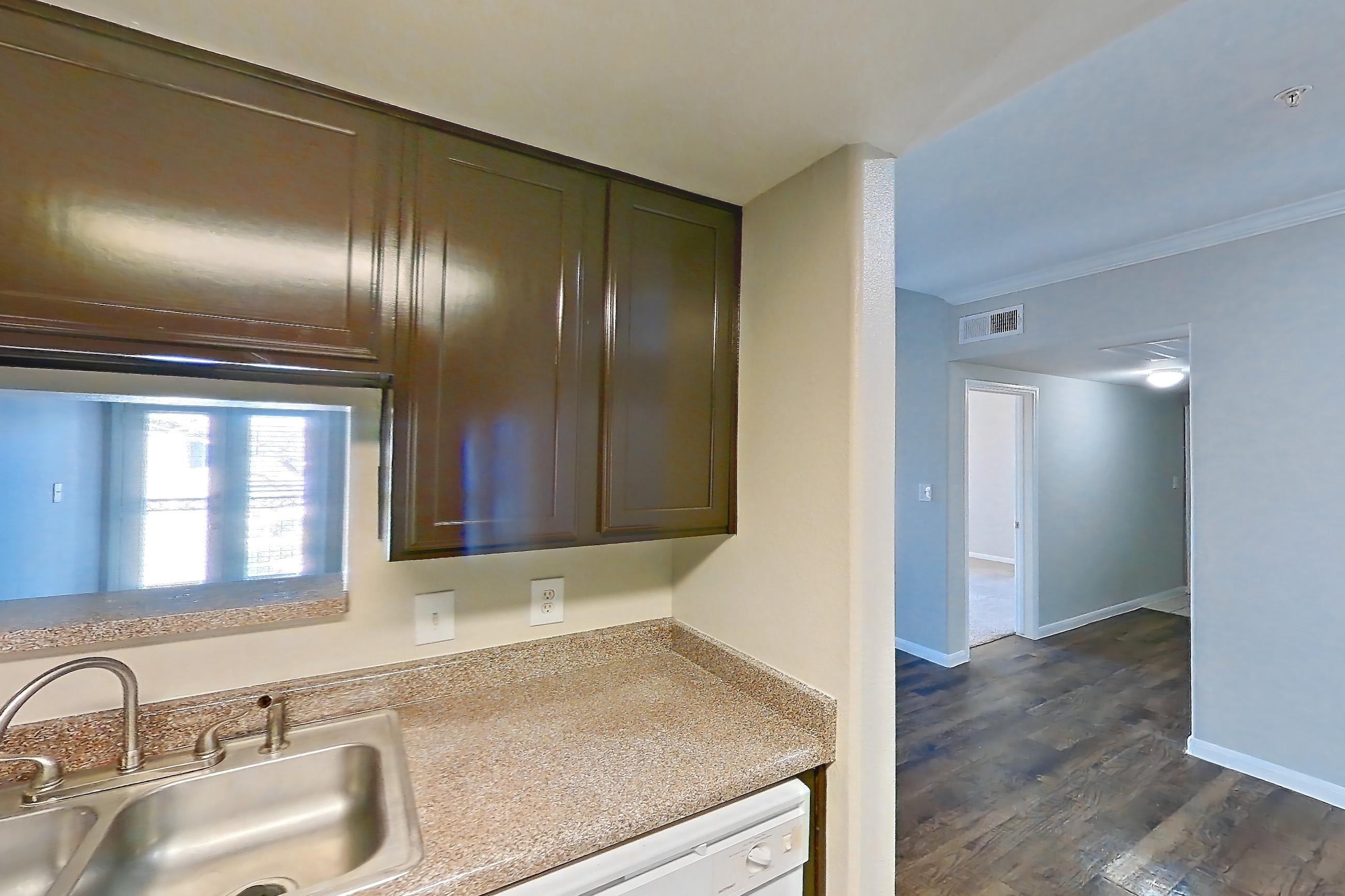 Kitchen with dishwasher, light countertops, refrigerator, and white appliances, Apartment 0832 at Marquis on Westheimer