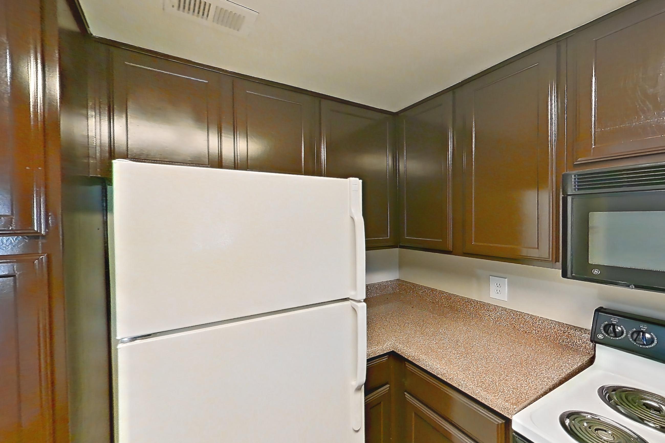 Kitchen with dishwasher, light countertops, refrigerator, and white appliances, Apartment 0832 at Marquis on Westheimer