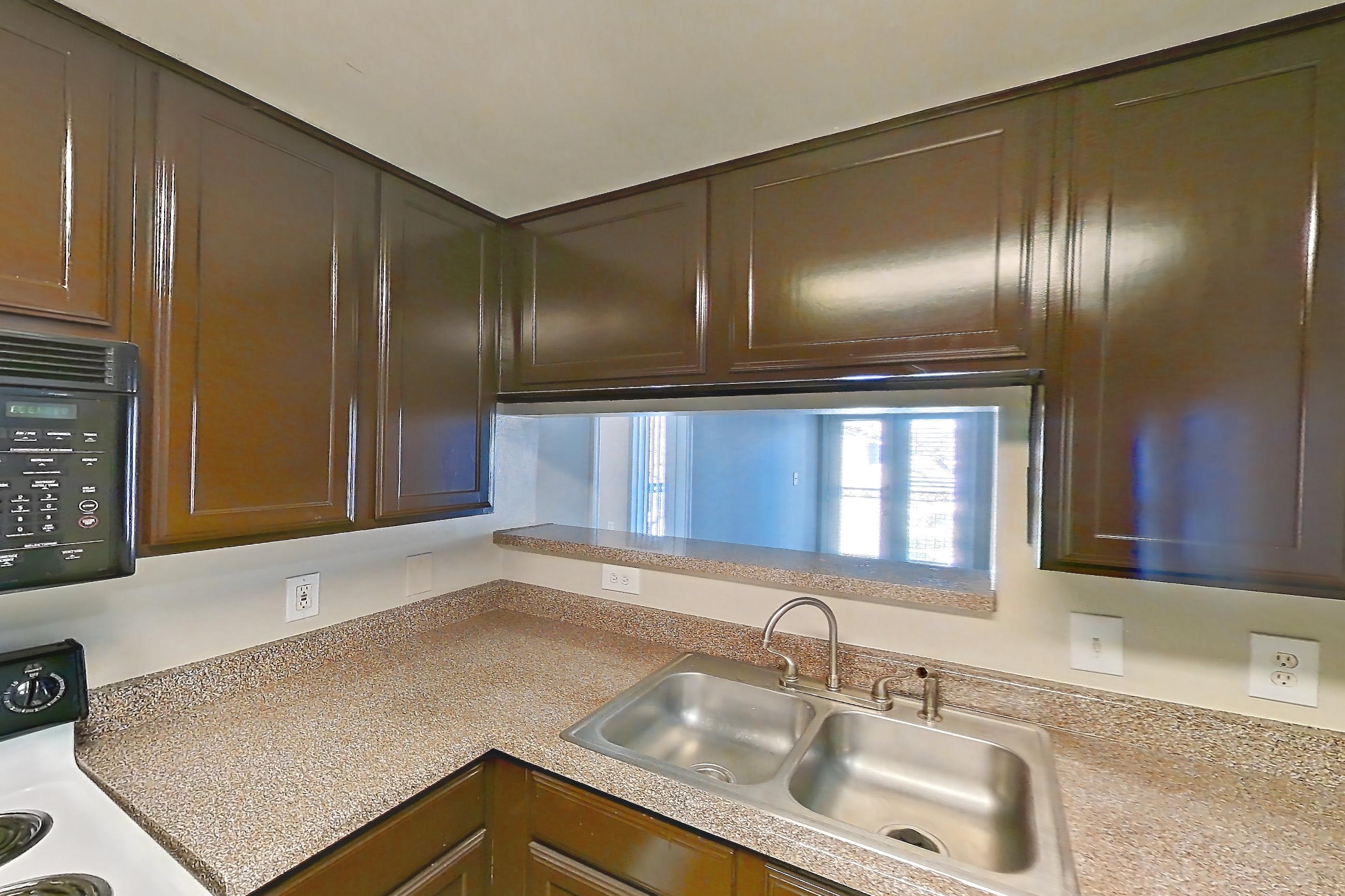 Kitchen with dishwasher, light countertops, refrigerator, and white appliances, Apartment 0832 at Marquis on Westheimer