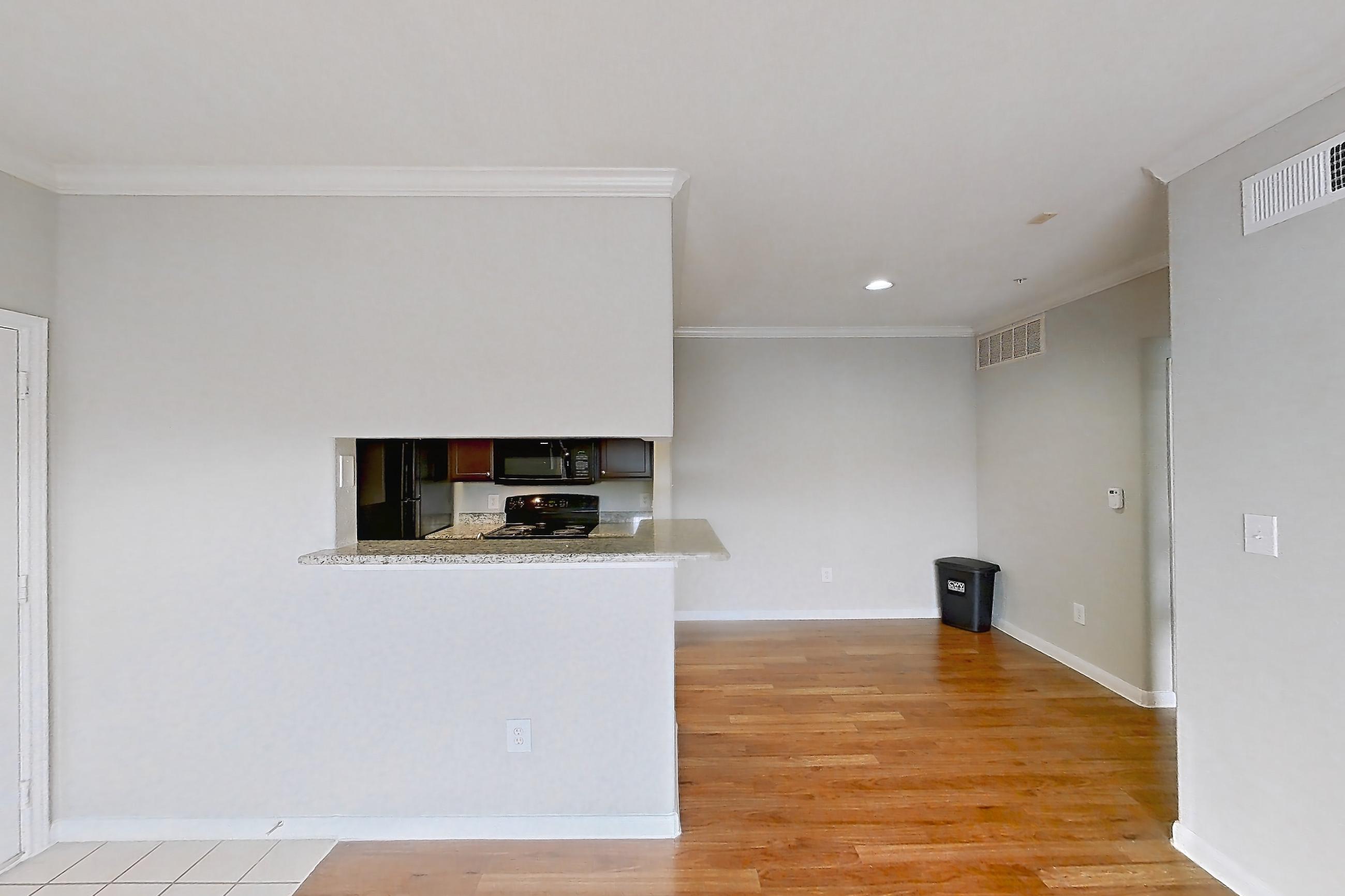 Living room with black appliances, electric range, light countertops, light wood-finish flooring, oven/range, and refrigerator, Apartment 1138 at Marquis on Westheimer