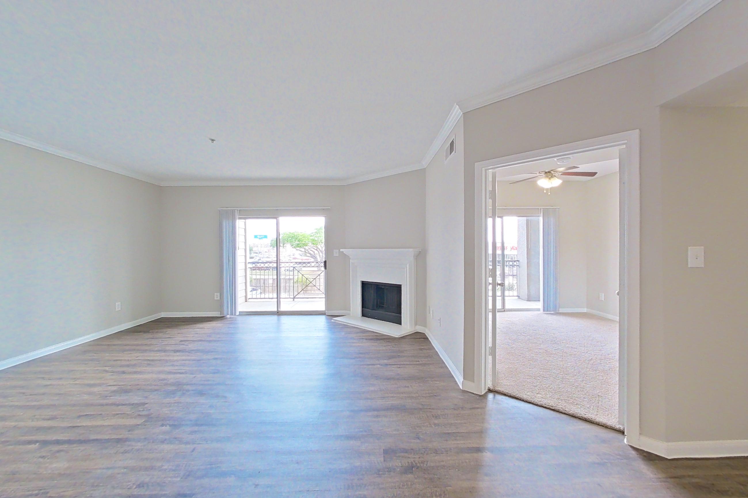 Dining room with dark wood-finish flooring, electric range, fireplace, light countertops, oven/range, and white appliances, Apartment 1223 at Marquis on Westheimer