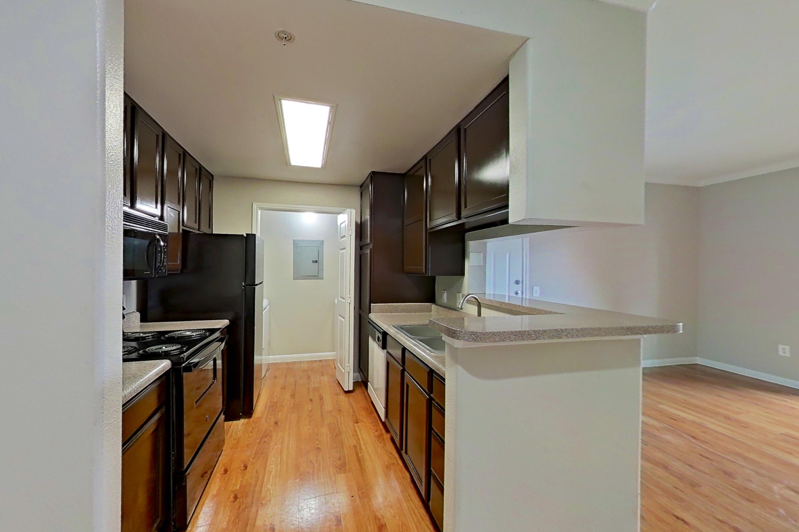 Dining room with light countertops and light wood-finish flooring, Apartment 1411 at Marquis on Westheimer