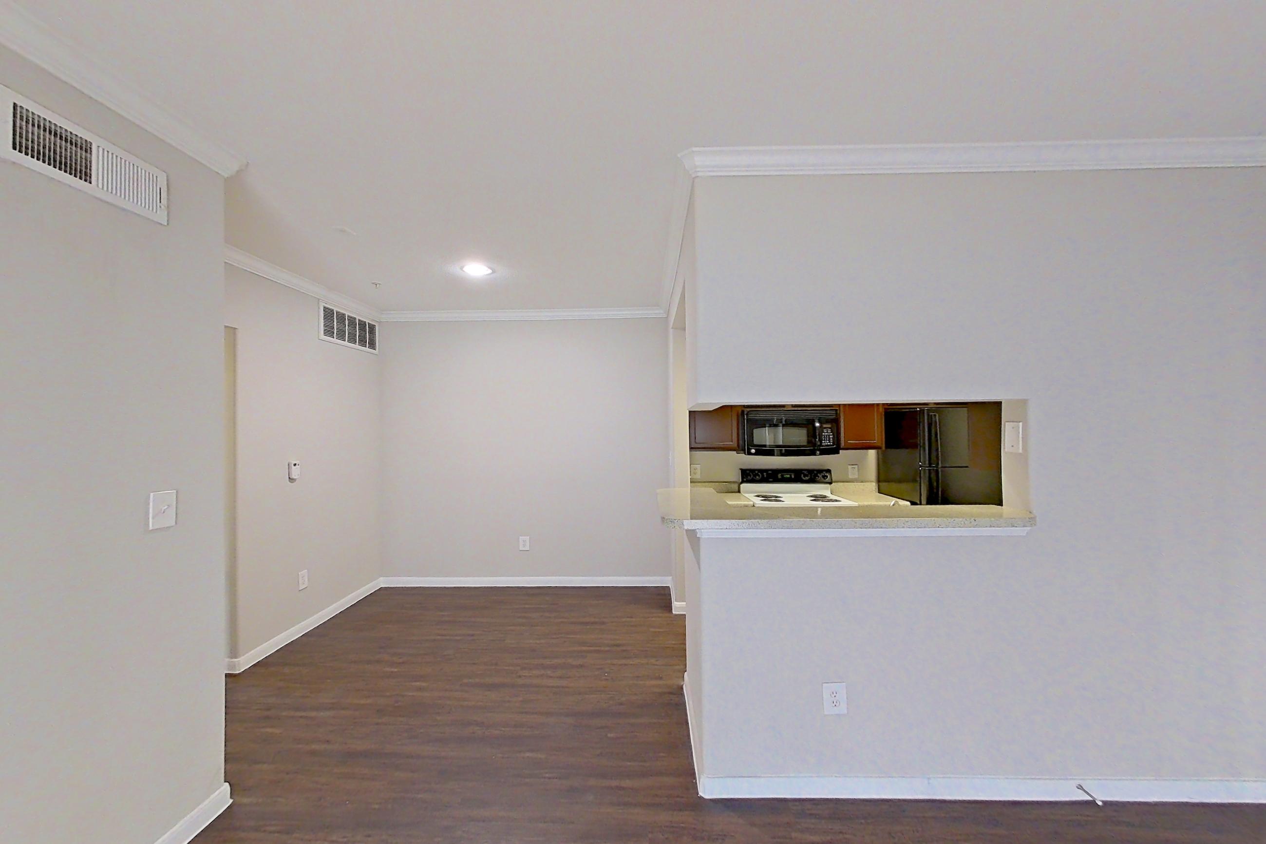 Living room with dark wood-finish flooring, electric range, oven/range, refrigerator, and white appliances, Apartment 1435 at Marquis on Westheimer
