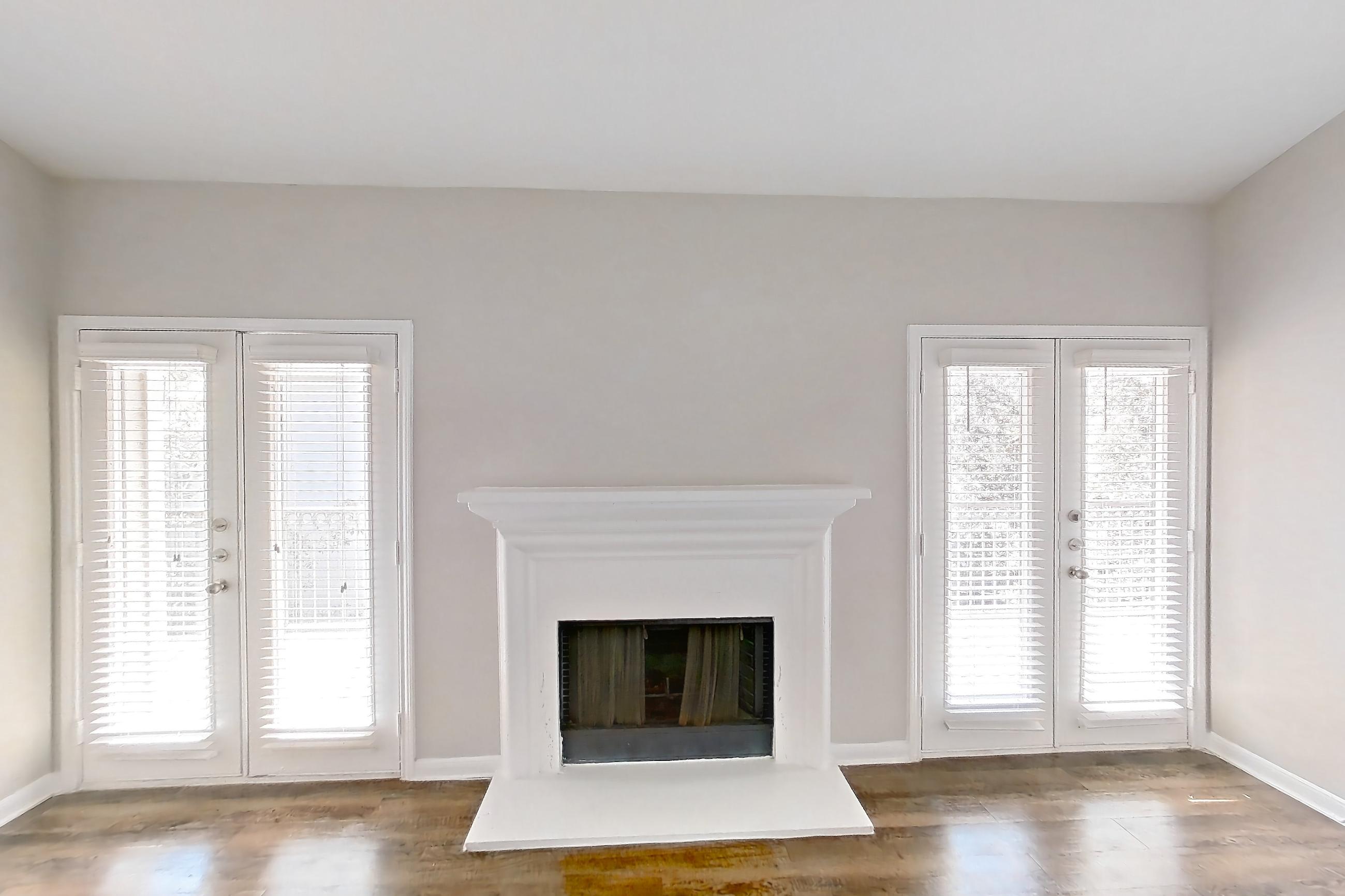 Living room with dark wood-finish flooring and fireplace, Apartment 1437 at Marquis on Westheimer