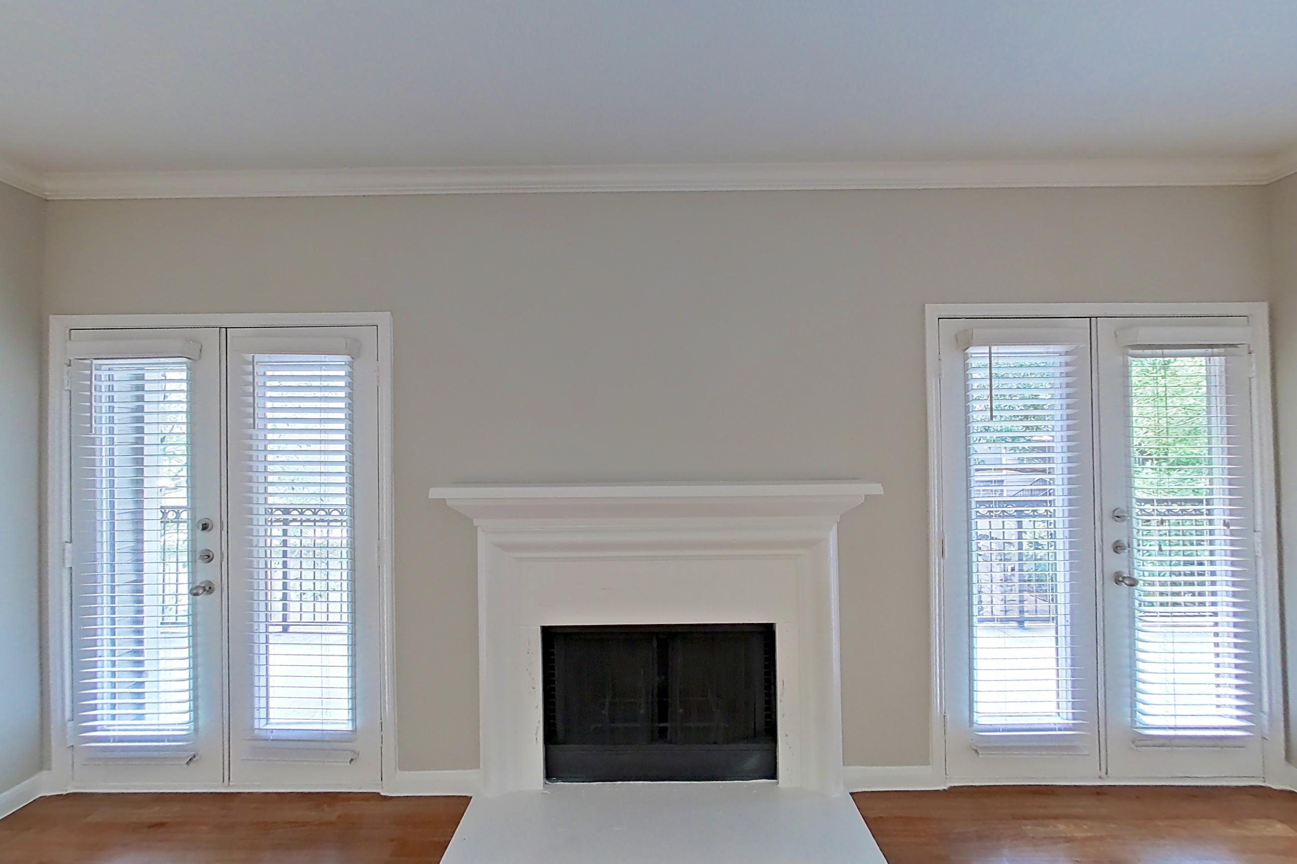 Living room with fireplace and light wood-finish flooring, Apartment 1427 at Marquis on Westheimer