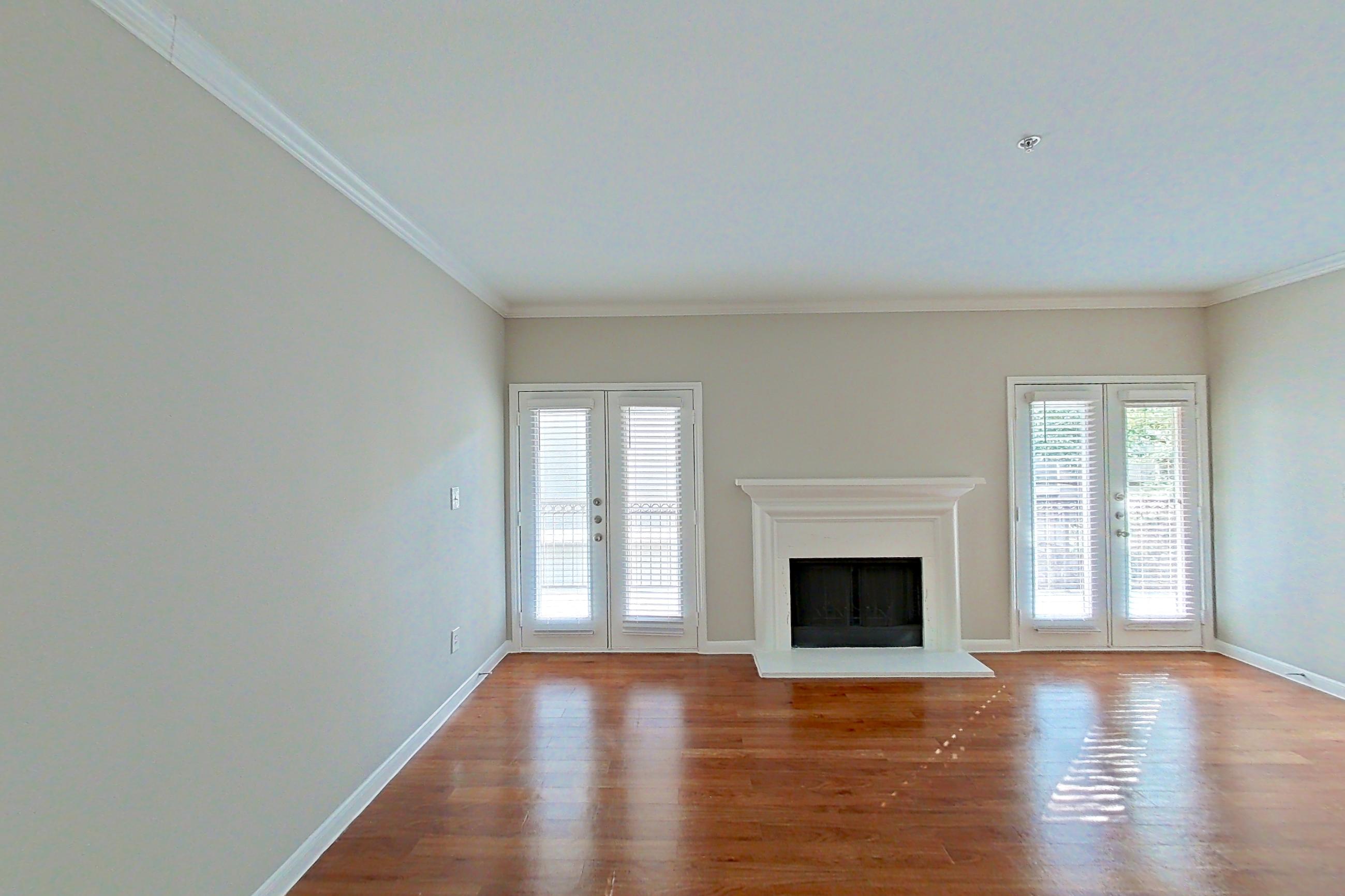 Living space with fireplace and light wood-finish flooring, Apartment 1427 at Marquis on Westheimer
