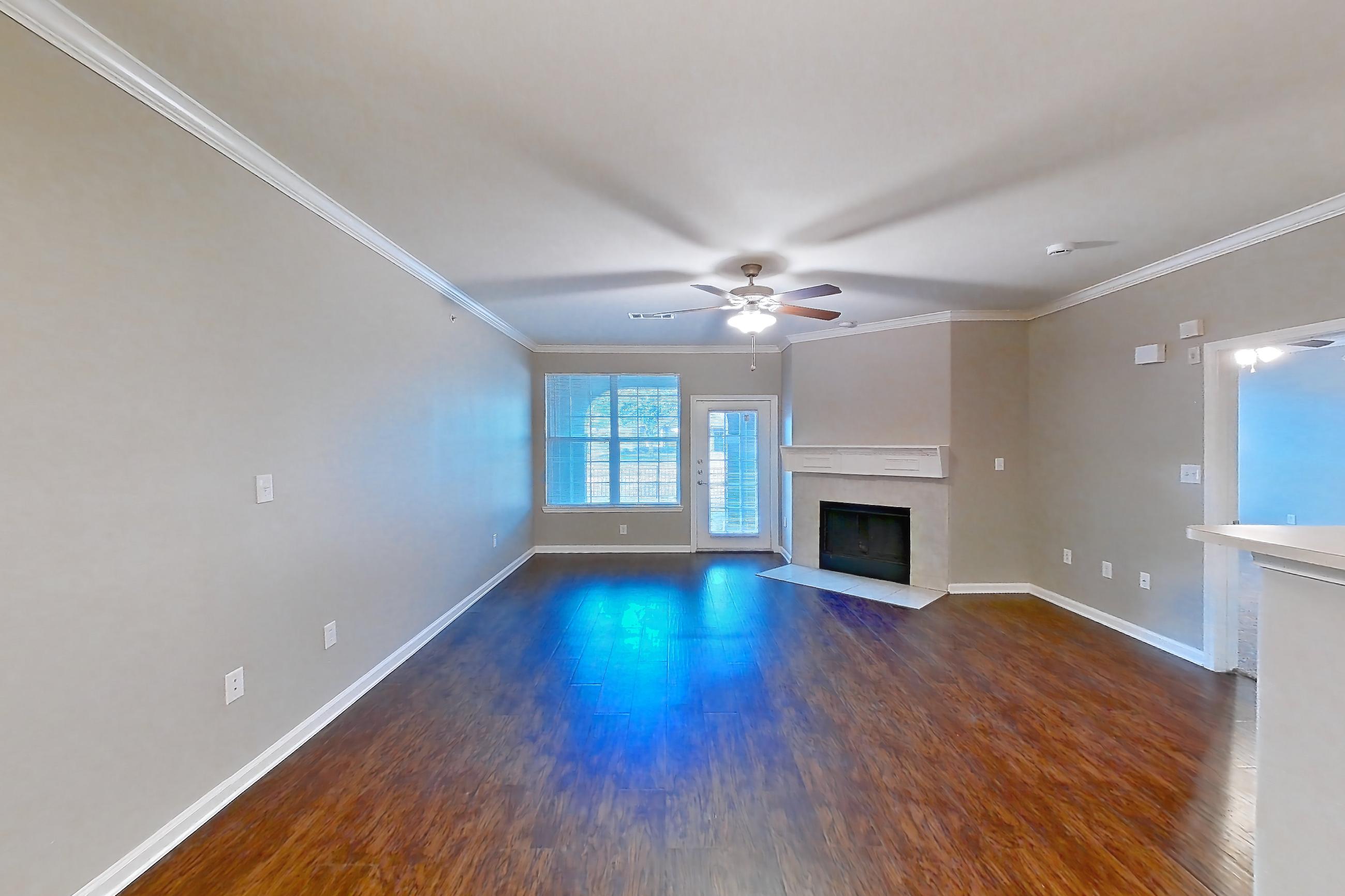 Dining room with dark tile flooring, dark wood-finish flooring, fireplace, refrigerator, tile fireplace, and white appliances, Apartment 1-0603 at Marquis at The Cascades I