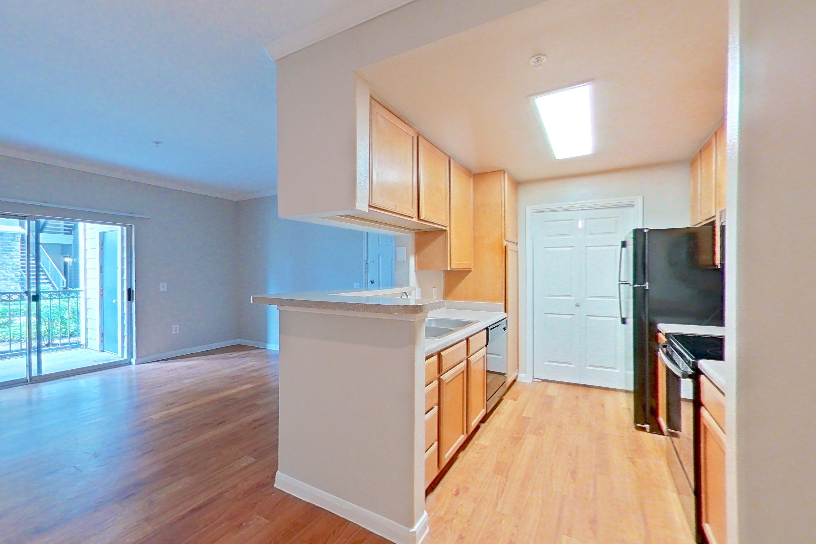 Dining room with electric range, light countertops, and light wood-finish flooring, Apartment 0118 at Marquis on Westheimer