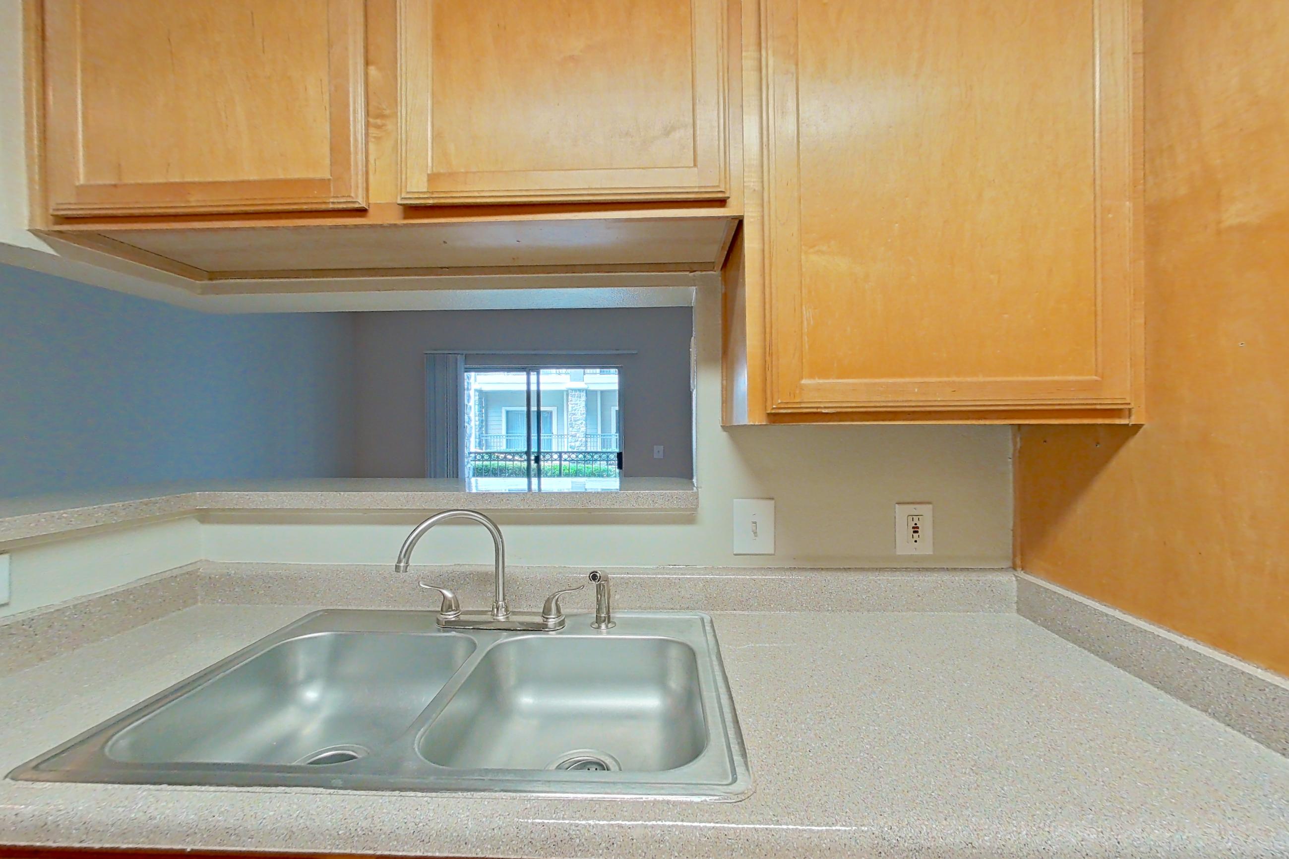 Kitchen with black appliances, electric range, light countertops, light wood-finish flooring, oven/range, and refrigerator, Apartment 0118 at Marquis on Westheimer