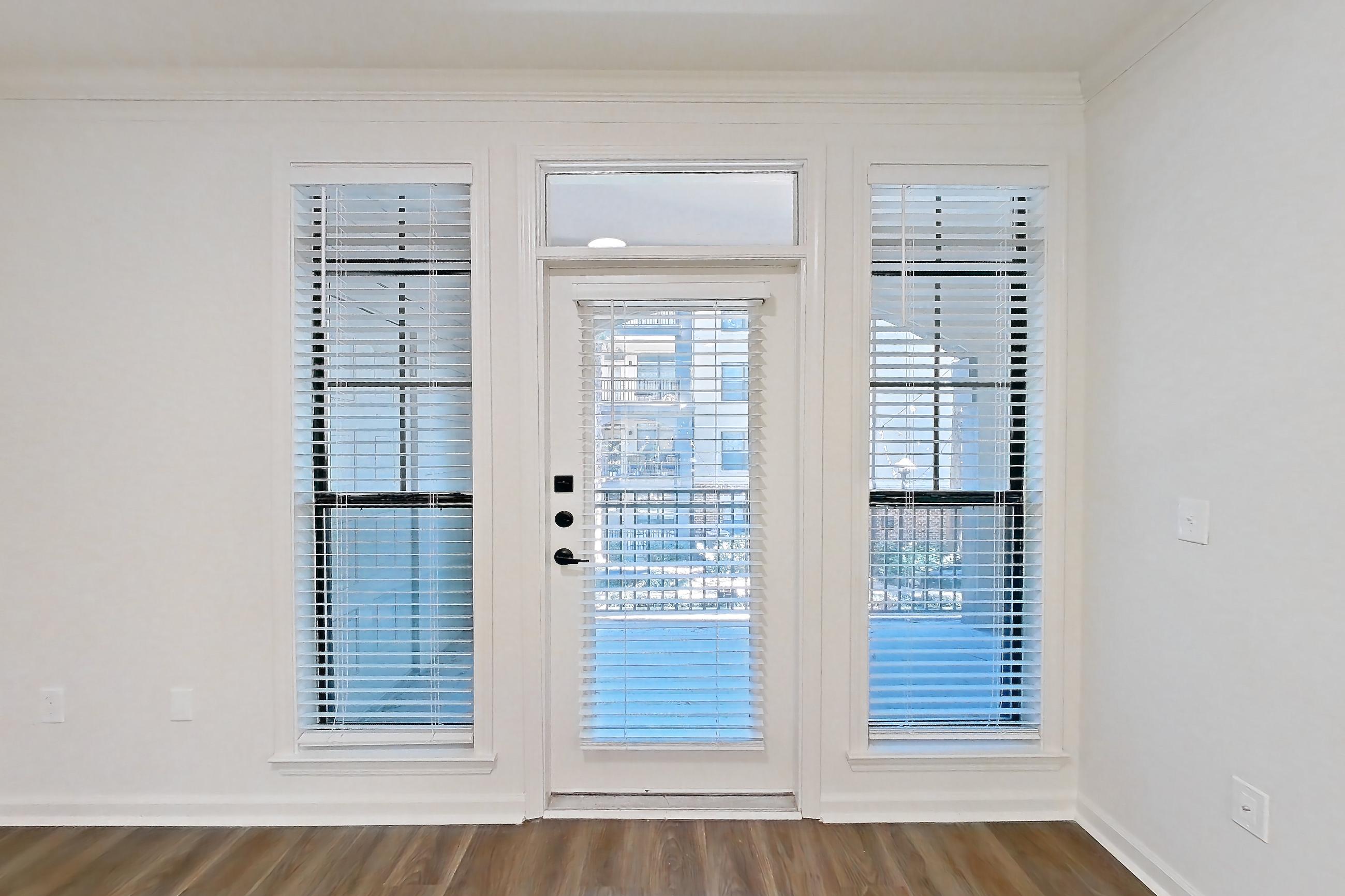 Living room with dark wood-finish flooring, Apartment 12202 at Cortland at Armour Yards