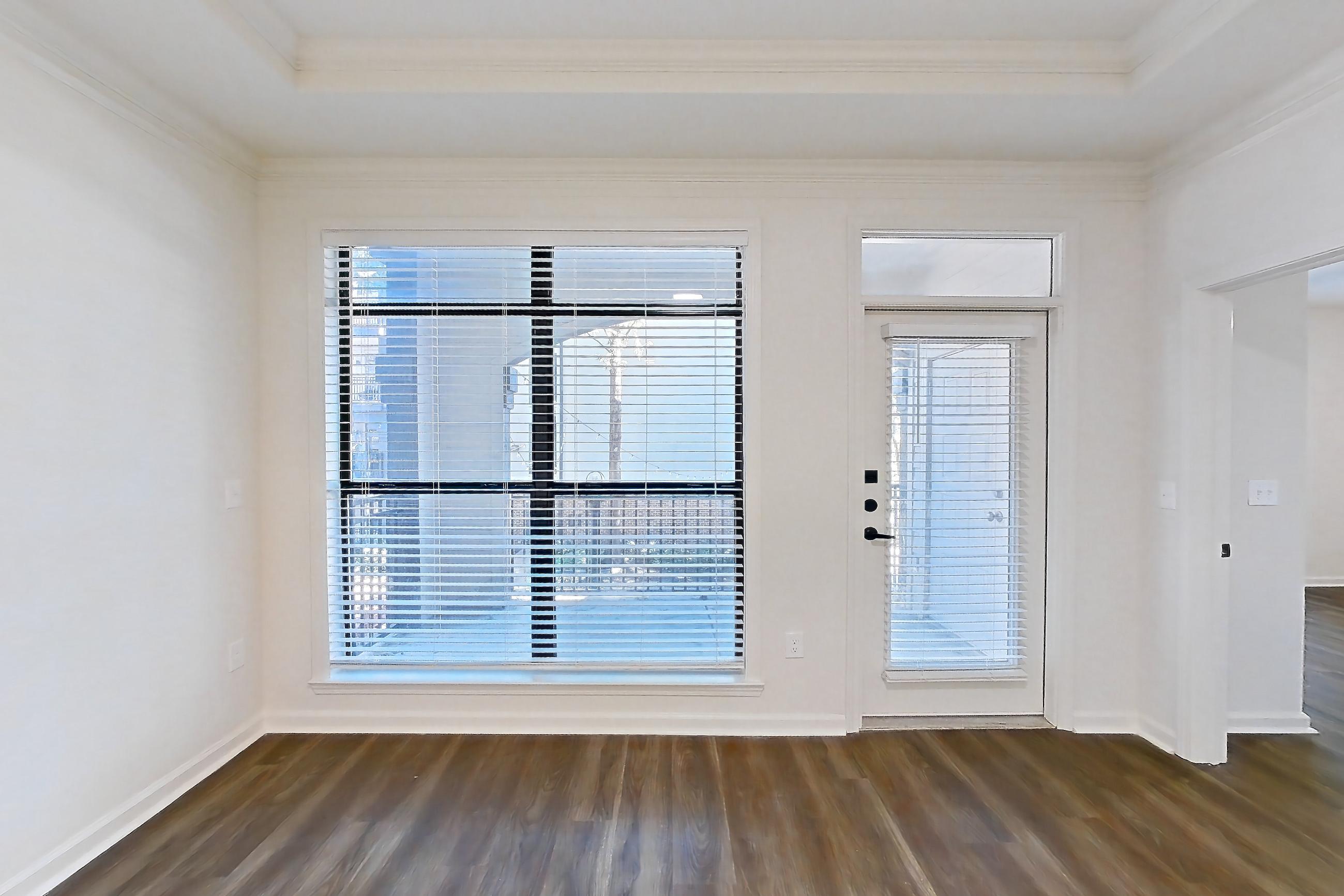 Living room with dark wood-finish flooring, Apartment 12203 at Cortland at Armour Yards