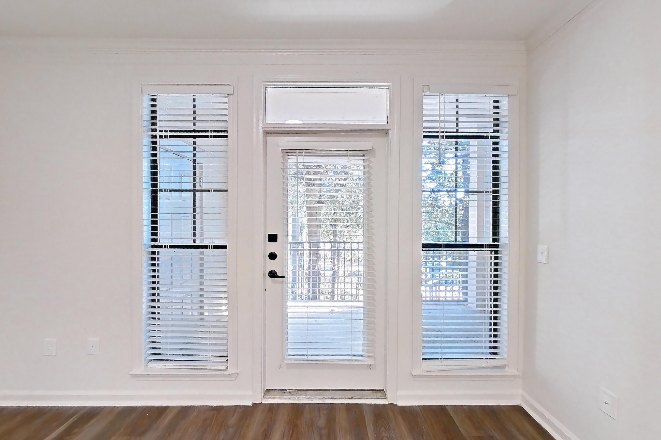 Living room with dark wood-finish flooring, Apartment 12304 at Cortland at Armour Yards