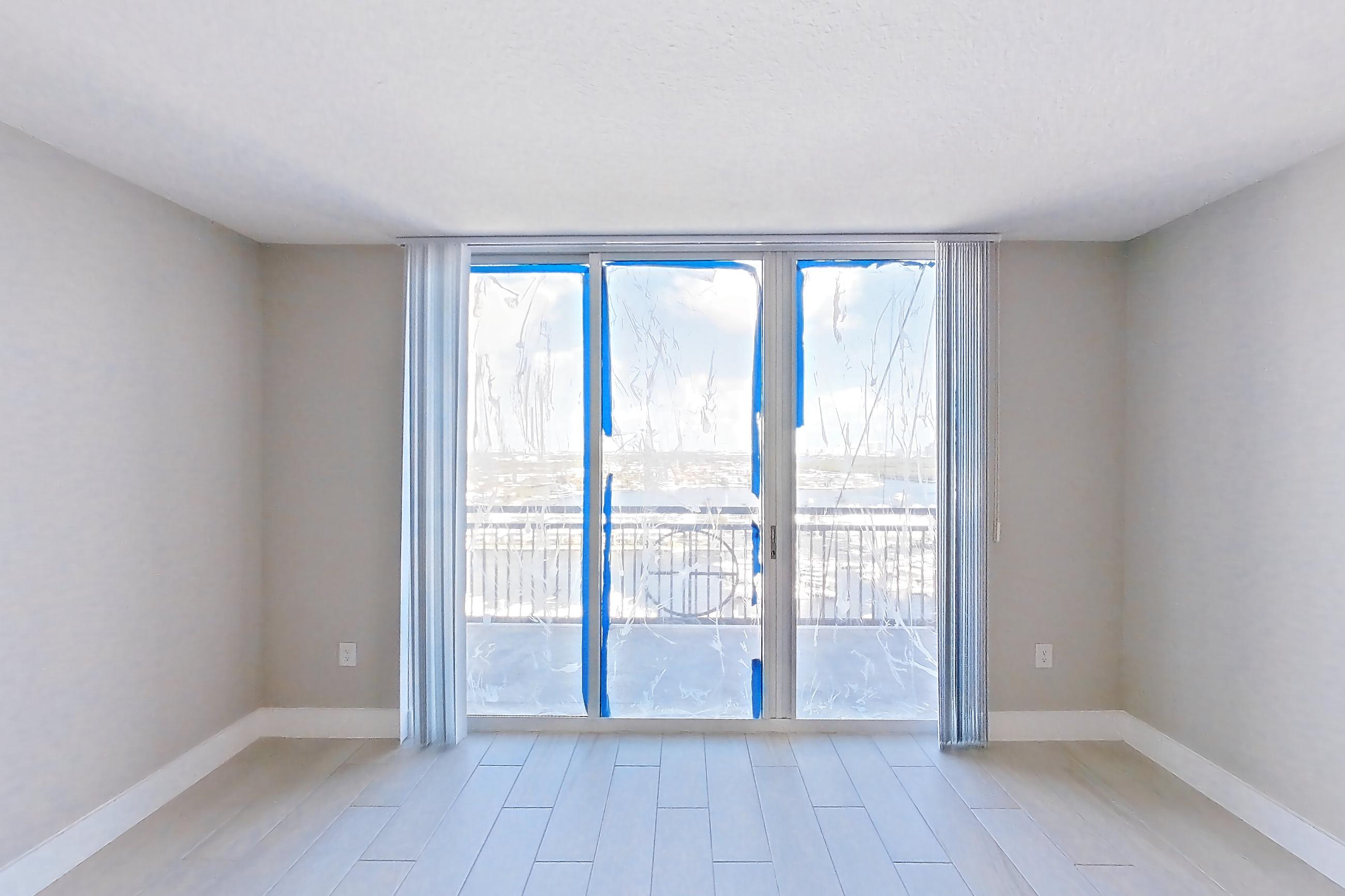 Living room with light wood-finish flooring and wood-look tile flooring, Apartment 1706 at Sunrise Harbor