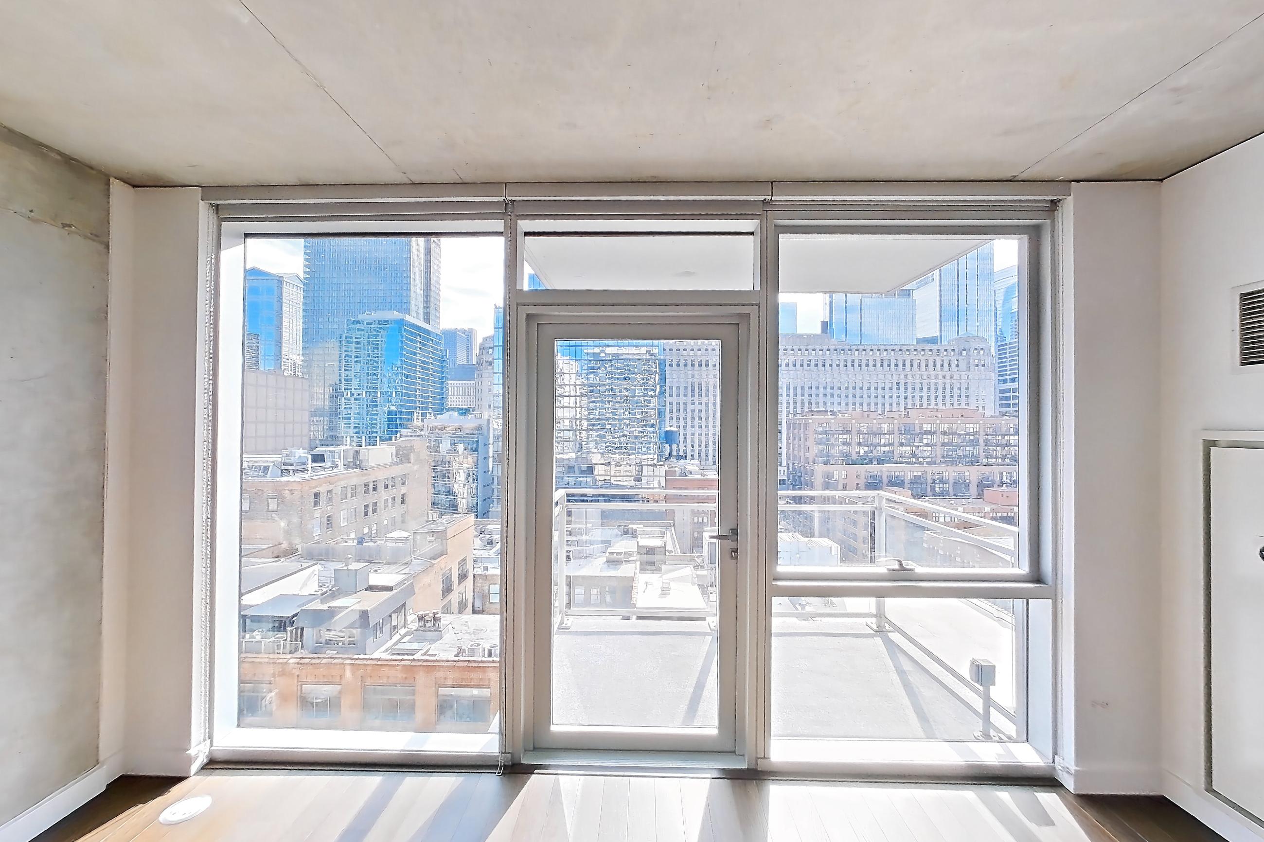 Living room with city view, dark wood-finish flooring, and skyline view, Apartment 1304 at 220 WIL