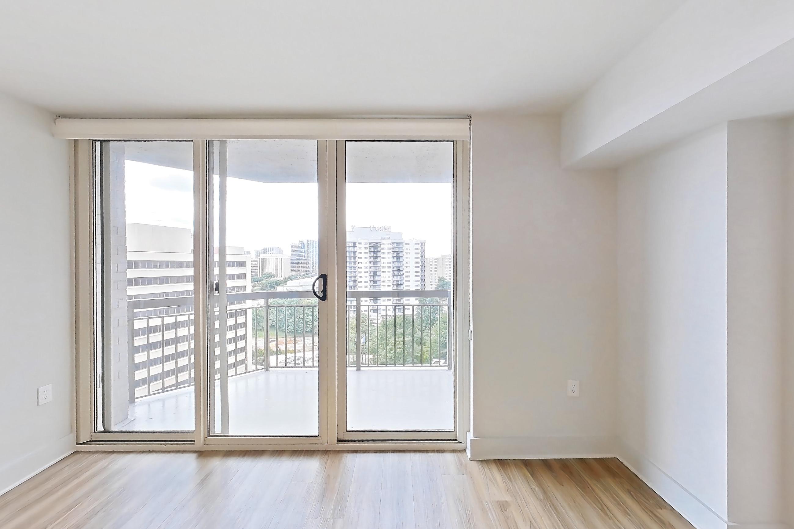 Living room with light wood-finish flooring, Apartment 01-1220 at Cortland Pentagon City