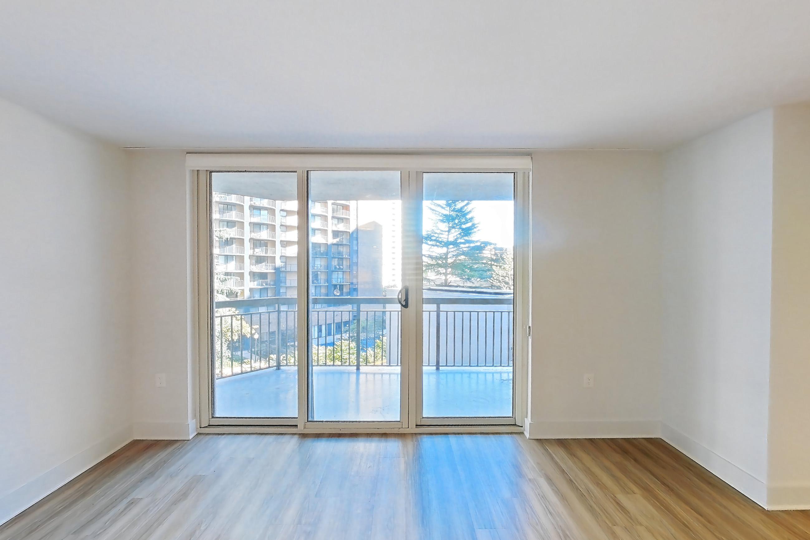 Living room with light wood-finish flooring, Apartment 01-0409 at Cortland Pentagon City