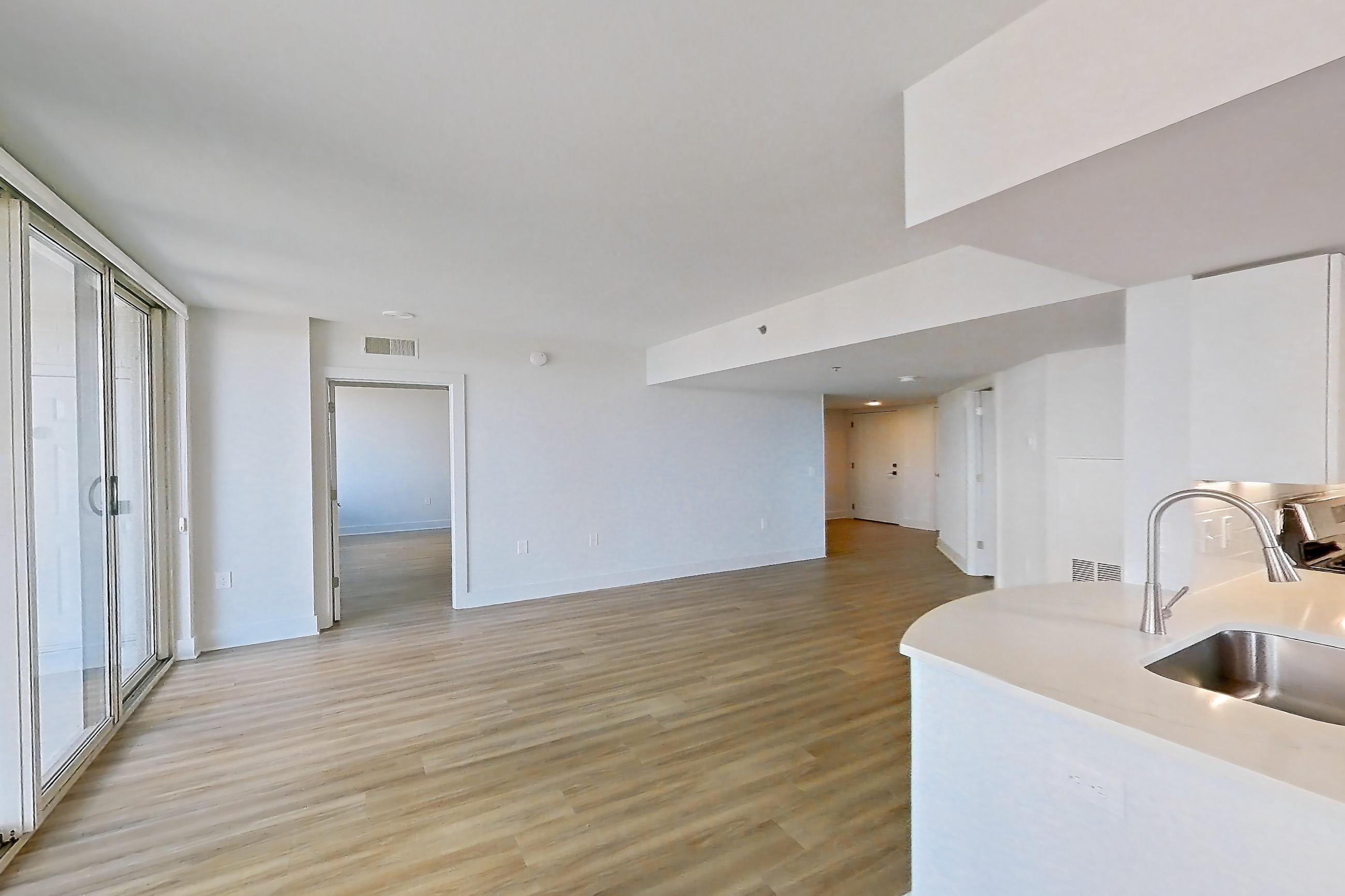 Dining area with city view, gas cooktop, light countertops, and light wood-finish flooring, Apartment 01-0901 at Cortland Pentagon City