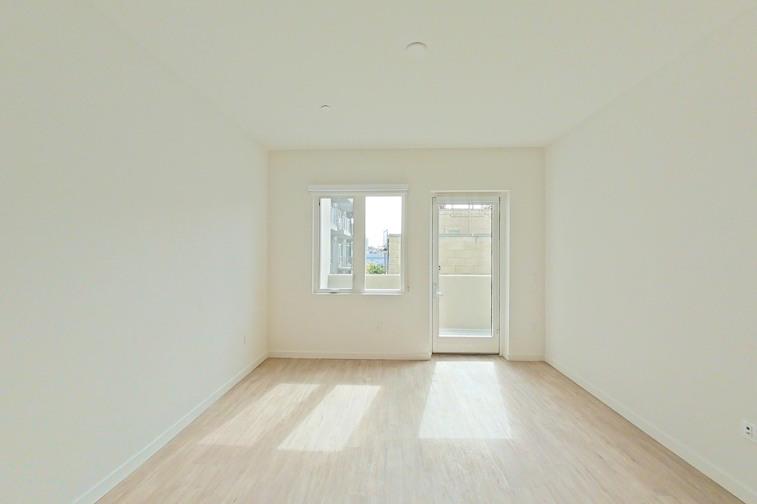Living room with light wood-finish flooring, Apartment 319 at Denizen