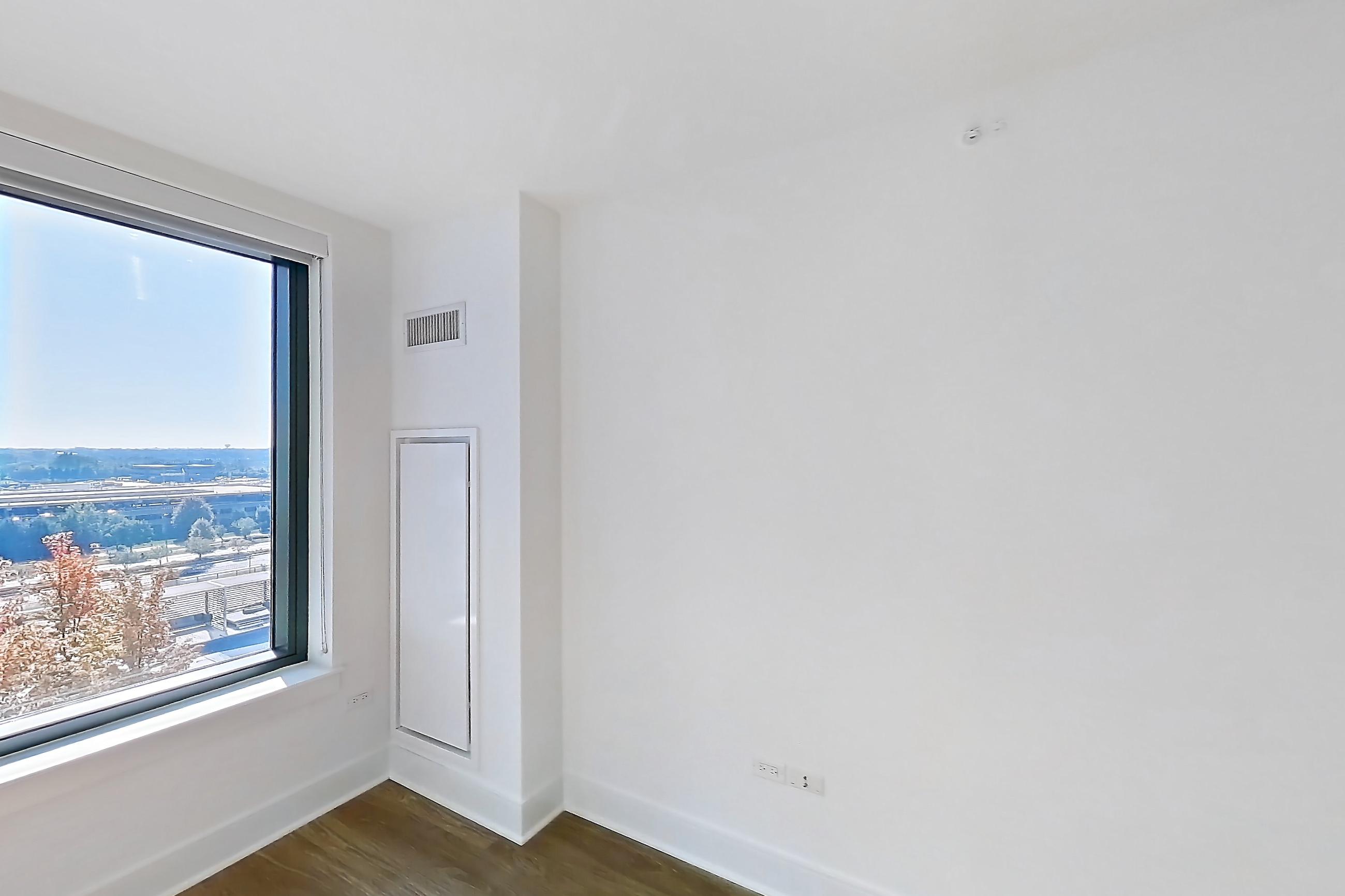 Living room with dark wood-finish flooring, Apartment 816 at One Oak Brook Commons