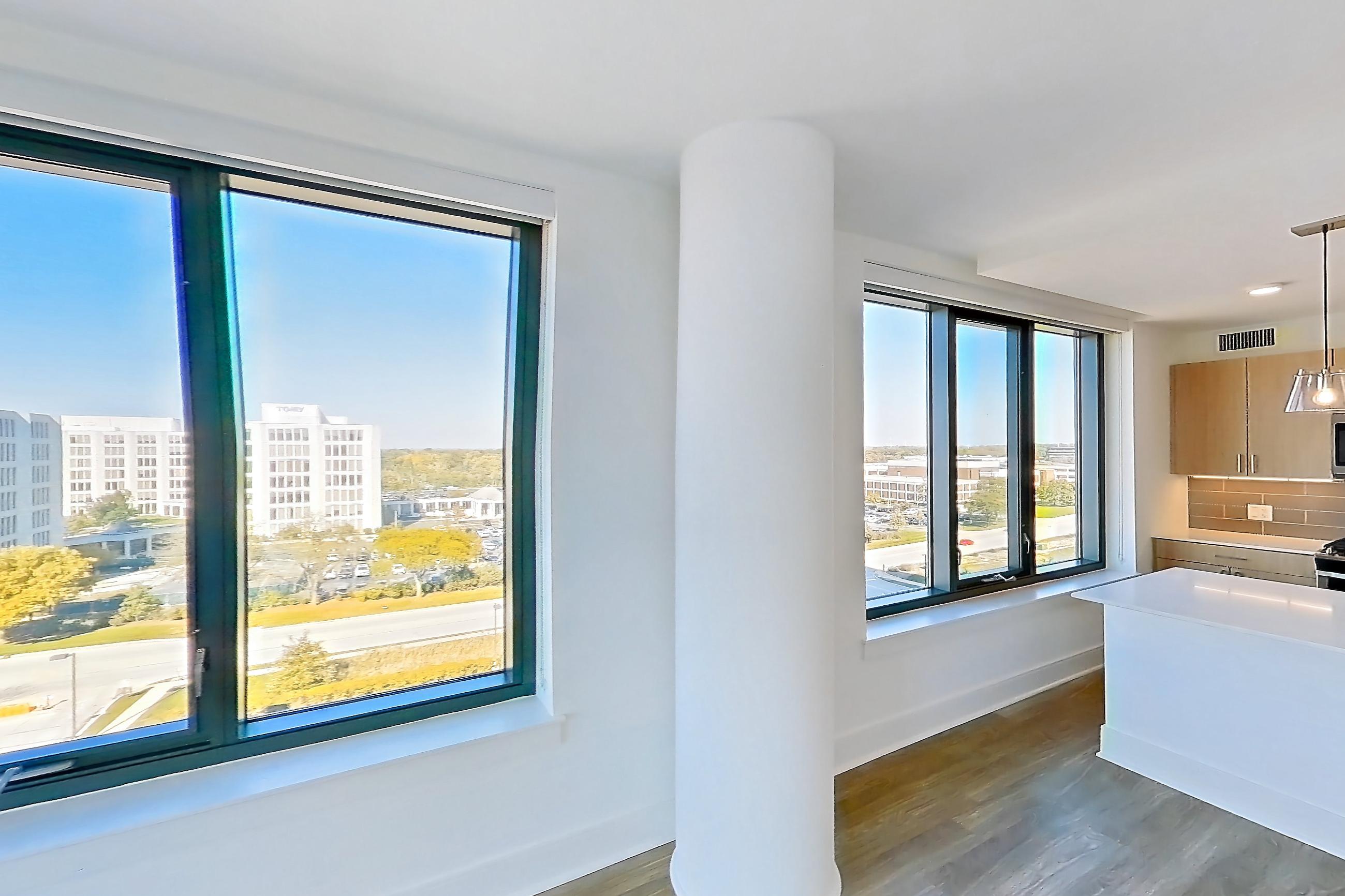 Living room with dark wood-finish flooring and light wood-finish flooring, Apartment 719 at One Oak Brook Commons