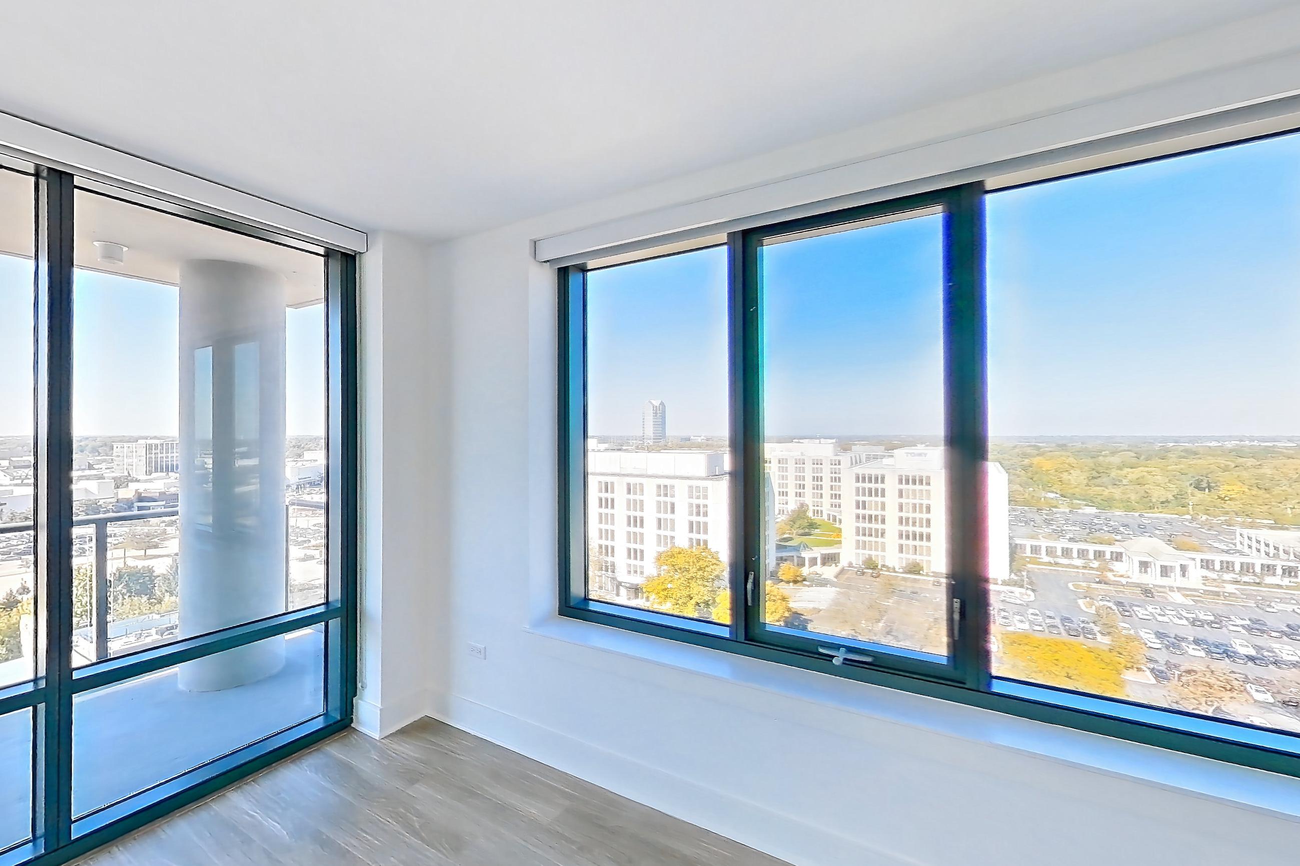 Living room with dark wood-finish flooring, Apartment 1319 at One Oak Brook Commons