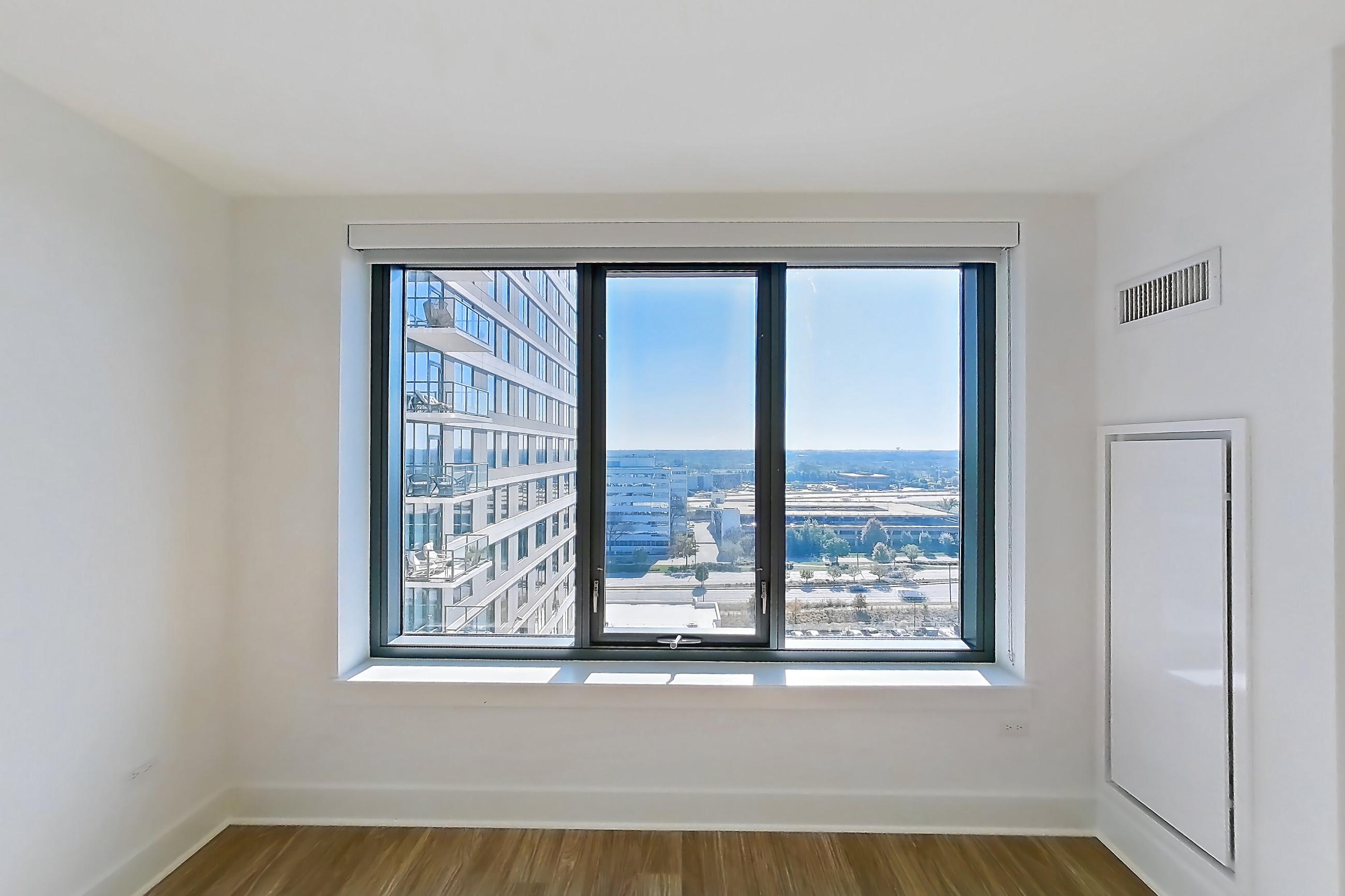 Living room with dark wood-finish flooring, Apartment 1216 at One Oak Brook Commons
